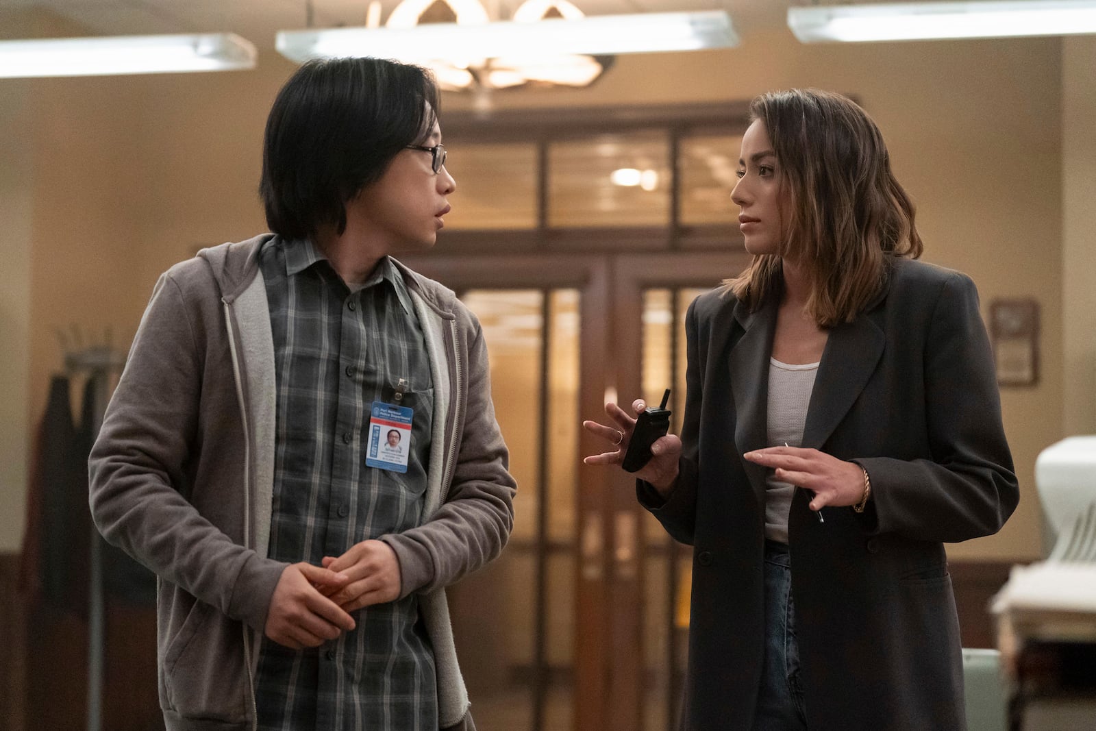 This image released by Hulu shows Chloe Bennet, right, and Jimmy O. Yang in a scene from the series "Interior Chinatown." (Mike Taing/Hulu via AP)