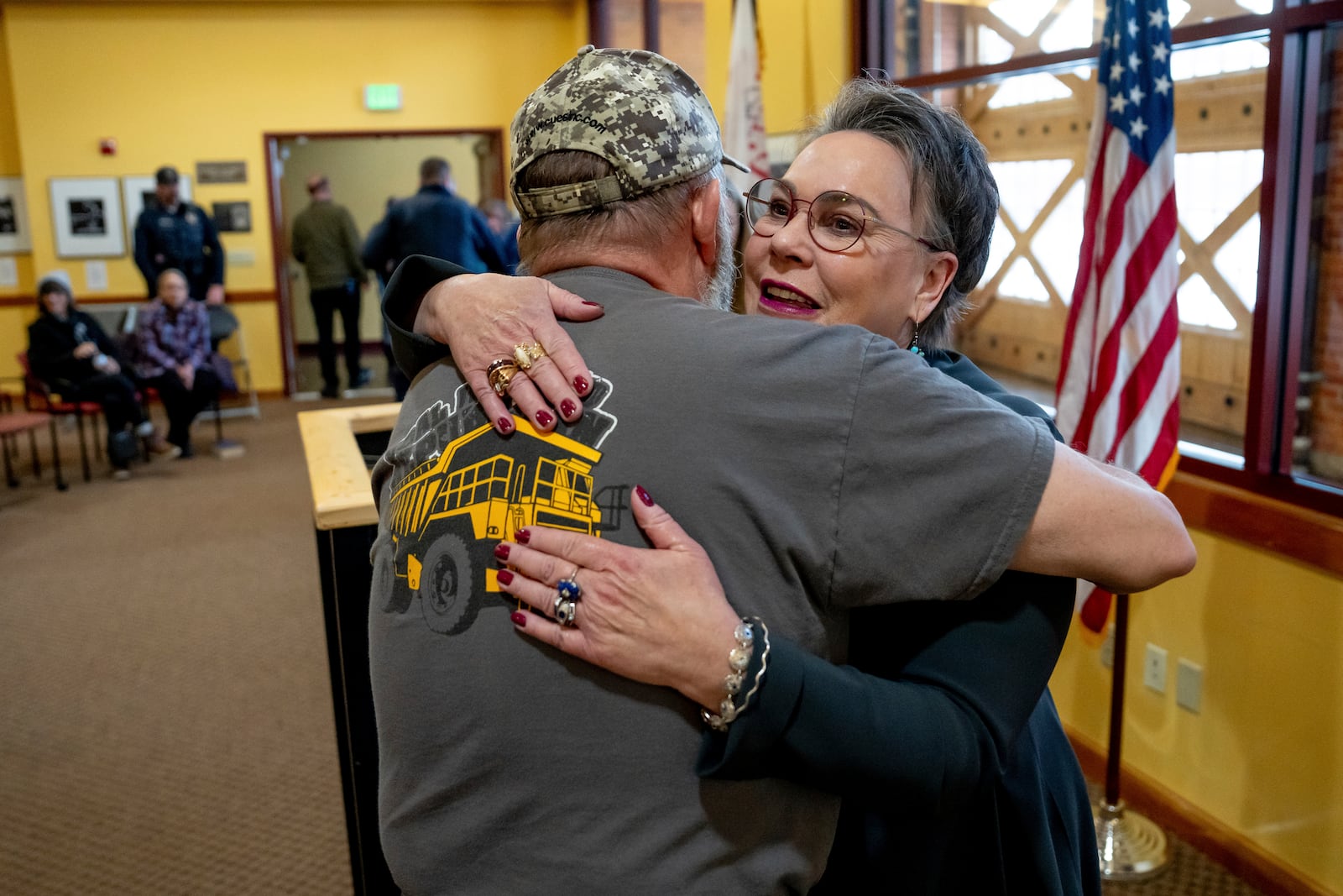 Rep. Harriet Hageman, R-Wyo., right, hugs Karl Allred, former secretary of state of Wyoming, before Hageman holds a town hall meeting on Friday, March 14, 2025, in Evanston, Wyo. (AP Photo/Spenser Heaps)