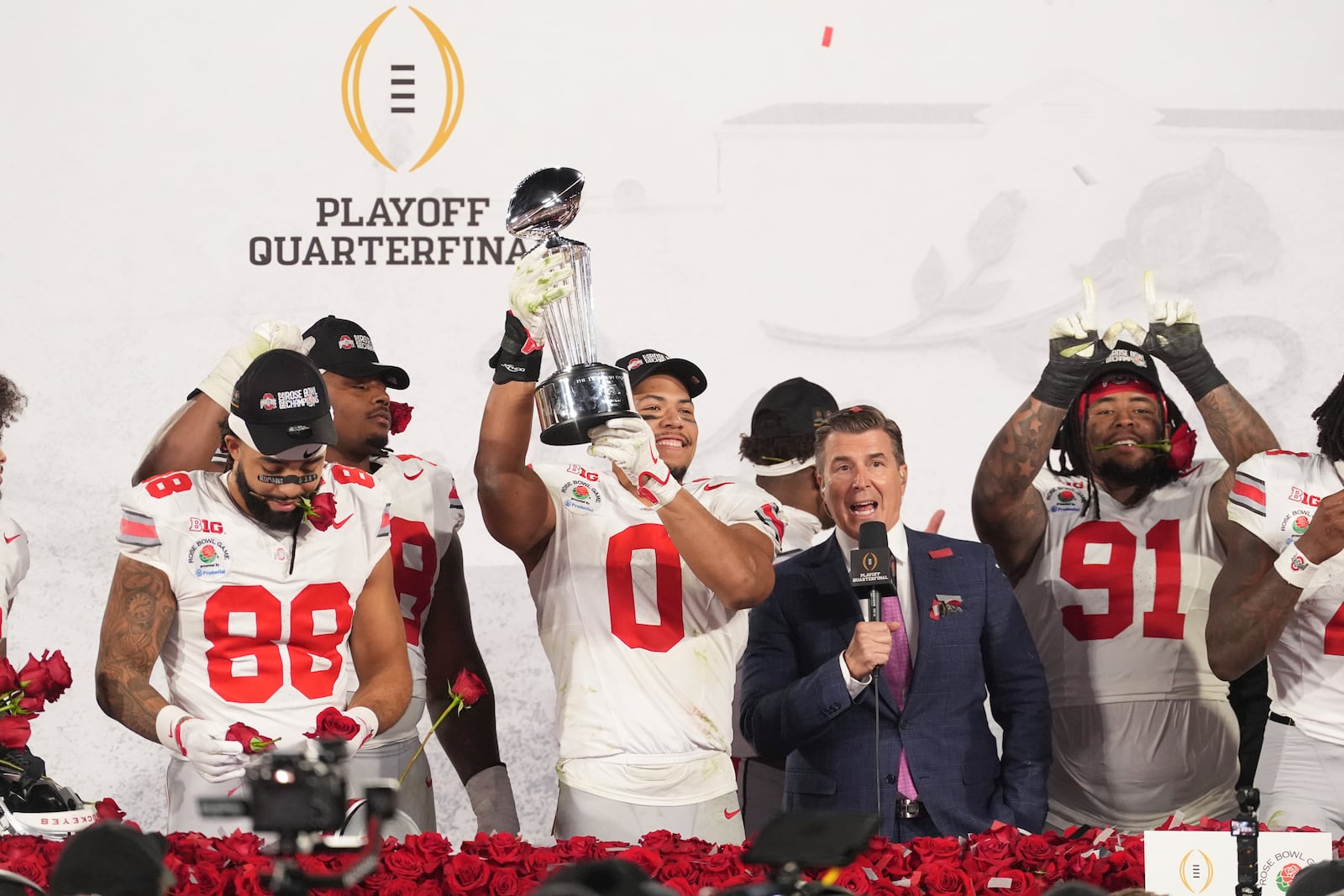 Ohio State linebacker Cody Simon (0) holds the trophy as he celebrates with teammates after the quarterfinals of the Rose Bowl College Football Playoff against Oregon, Wednesday, Jan. 1, 2025, in Pasadena, Calif. (AP Photo/Mark J. Terrill)