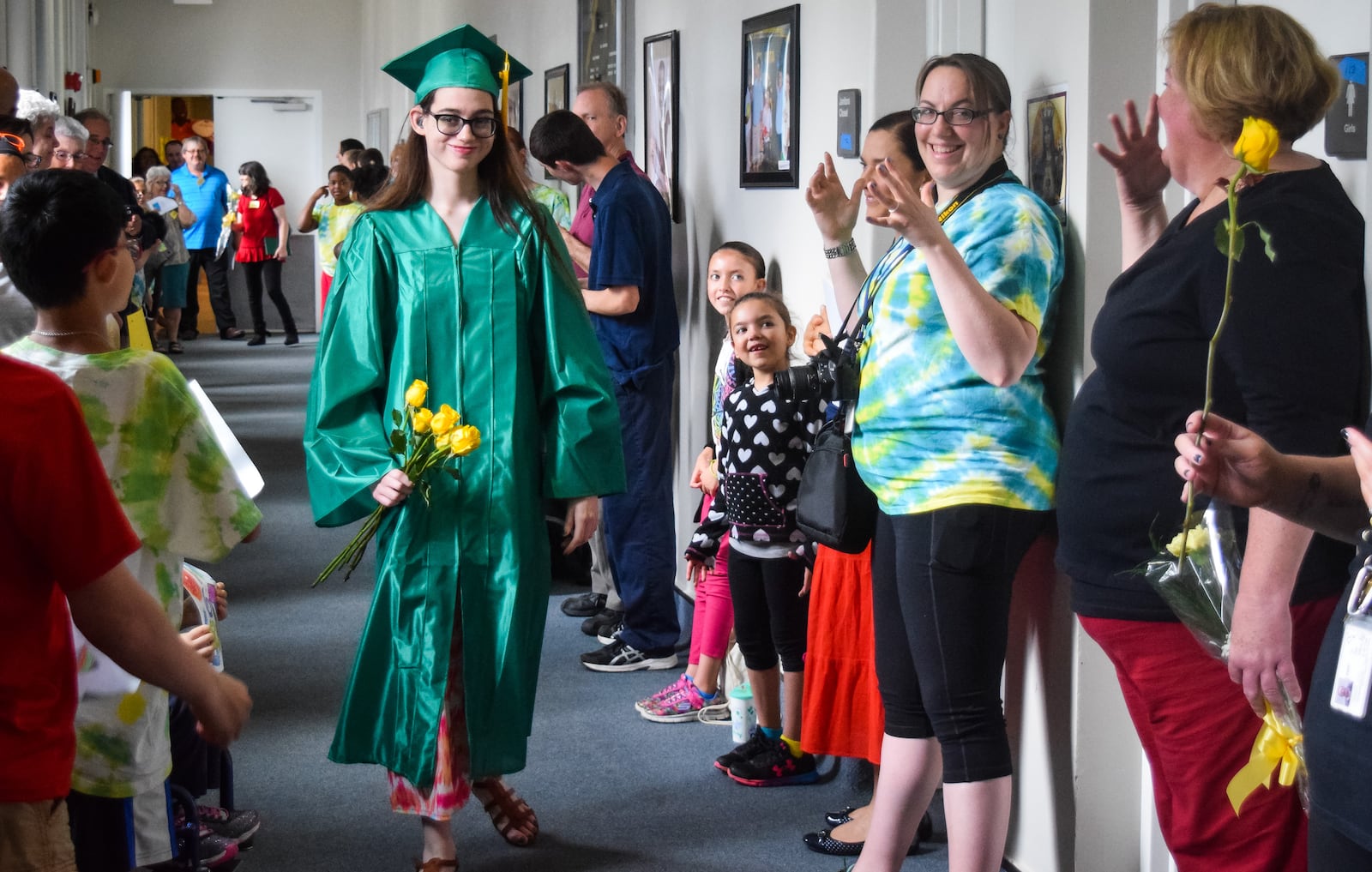 Tiffany Baker, of Hamilton, walks down the hall lined with students and faculty as she celebrates her graduation day May 29 at St. Rita School for the Deaf in Cincinnati. 