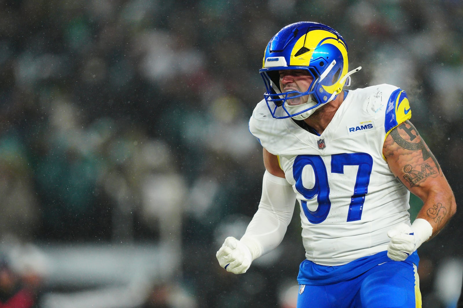 FILE - Los Angeles Rams linebacker Michael Hoecht (97) reacts after a tackle of Philadelphia Eagles running back Saquon Barkley (26) during the second half of an NFL football NFC divisional playoff game, Jan. 19, 2025, in Philadelphia. (AP Photo/Derik Hamilton, File)