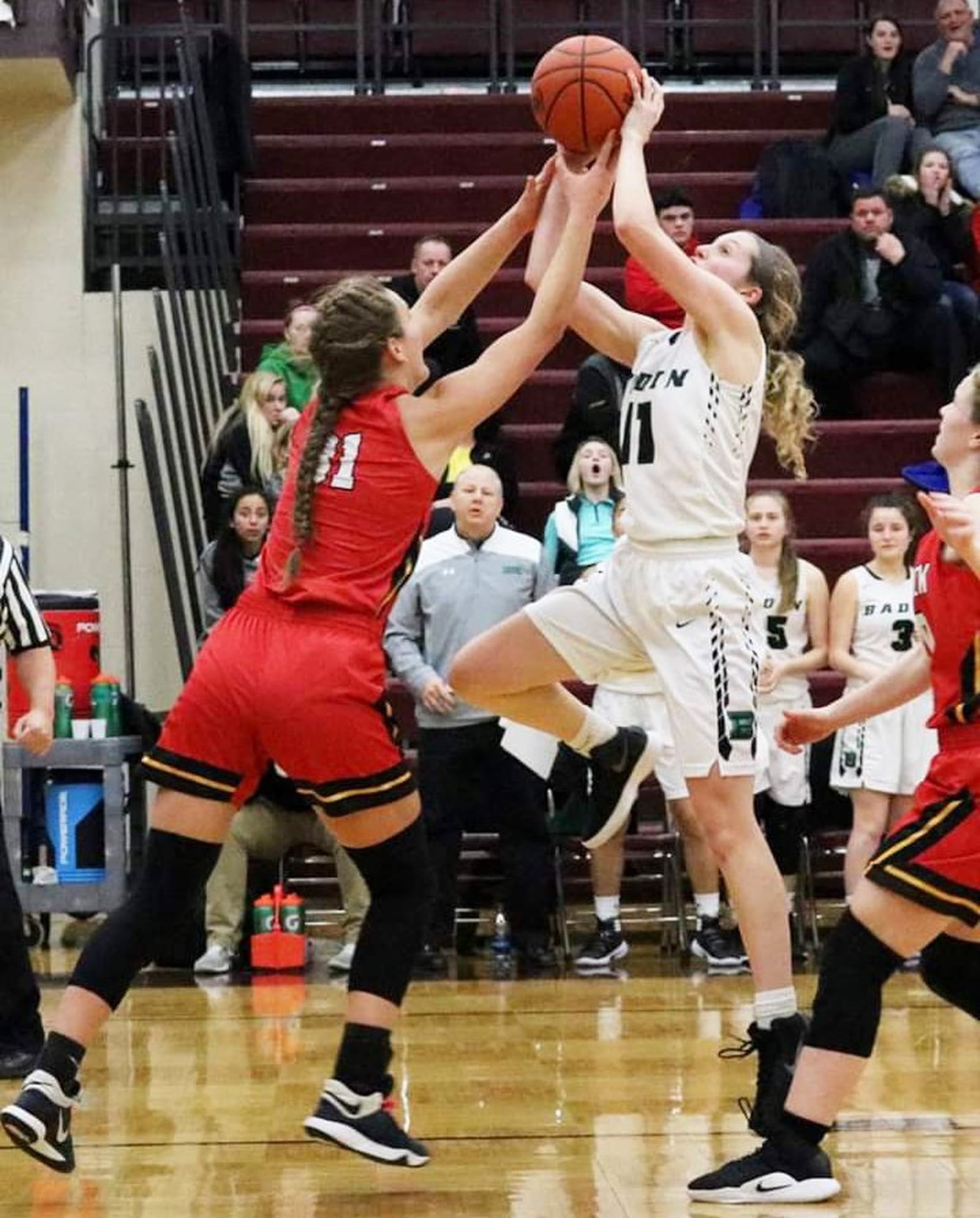 Fenwick’s Emily Adams (31) greets Badin’s Emily Maher (11) near the basket during Tuesday night’s Division II sectional game at Lebanon. Fenwick won 53-46. CONTRIBUTED PHOTO BY TERRI ADAMS