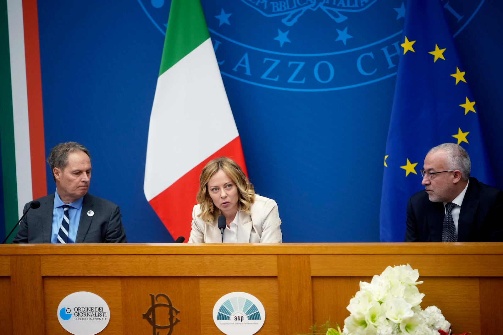 Italian Premier Giorgia Meloni holds the 2024 year-end press conference, flanked by the Italian president of the Order of Journalists, Carlo Bartoli, left, and Italian national press federation president Vittorio Di Trapani, in Rome, Thursday, Jan. 9, 2025. (AP Photo/Alessandra Tarantino)