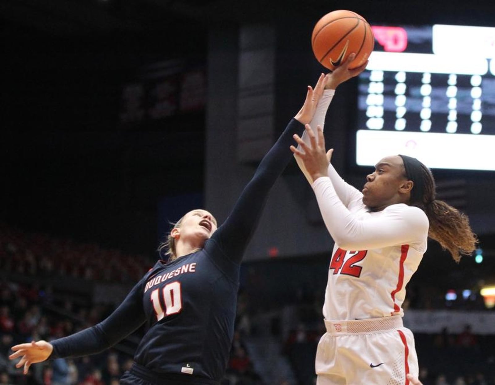 Duquesne’s Paige Cannon (10) goes after a shot by Dayton’s Jayla Scaife on Jan. 31 during a 79-79 victory for the host Flyers at the University of Dayton Arena. DAVID JABLONSKI/STAFF