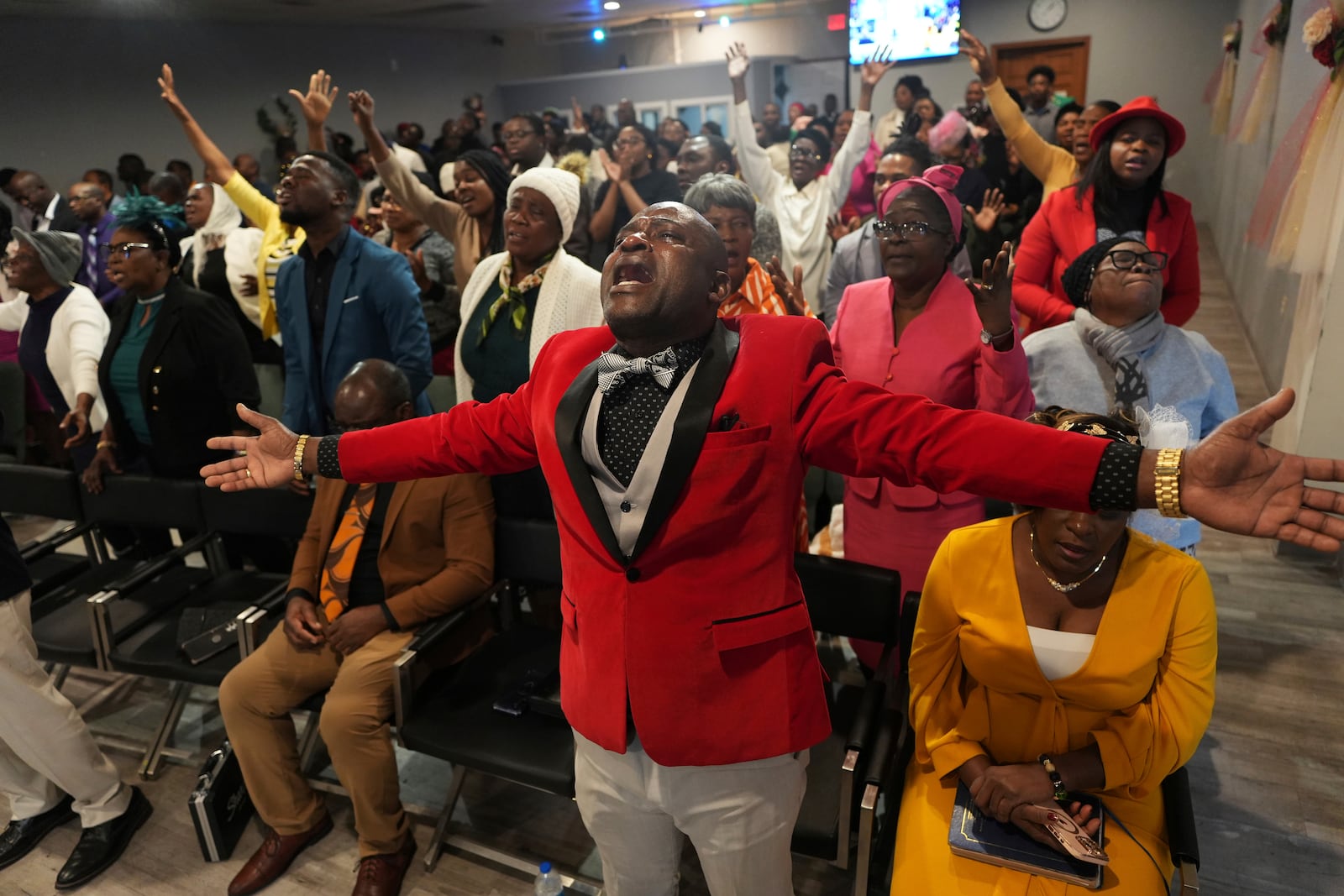 Jean-Michel Gisnel cries out while praying with other congregants at the First Haitian Evangelical Church of Springfield, Sunday, January 26, 2025, in Springfield, Ohio. (AP Photo/Luis Andres Henao)