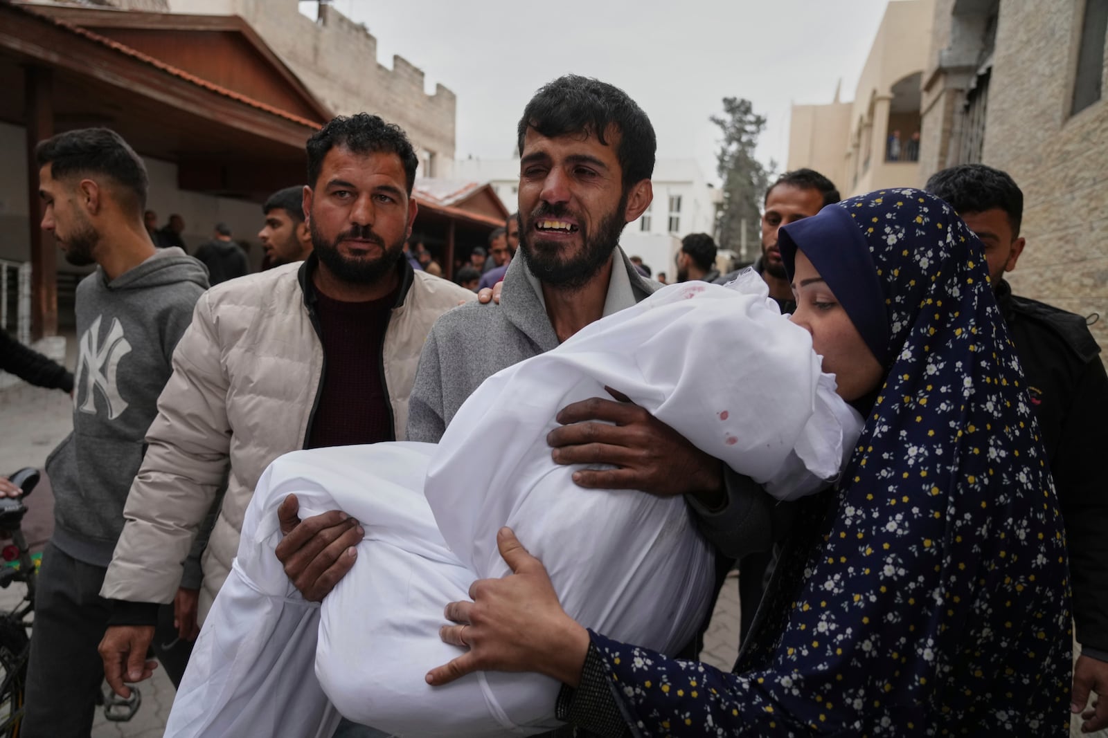 A Palestinian man carries the body of his 11 years old daughter Aya Al-Samri who was killed by an Israeli army airstrike, during her funeral at the Baptist Hospital in Gaza city, Friday, March 21, 2025. (AP Photo/Jehad Alshrafi)