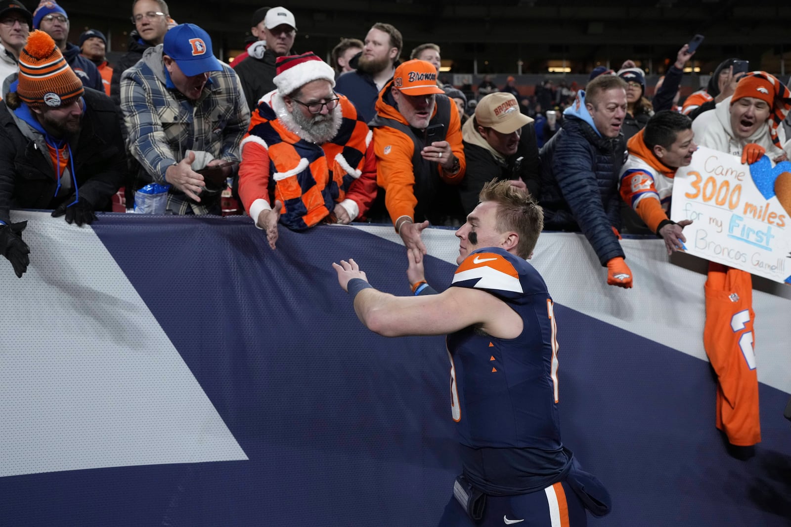 Denver Broncos quarterback Bo Nix celebrates with fans following an NFL football game against the Cleveland Browns, Monday, Dec. 2, 2024, in Denver. (AP Photo/Jack Dempsey)