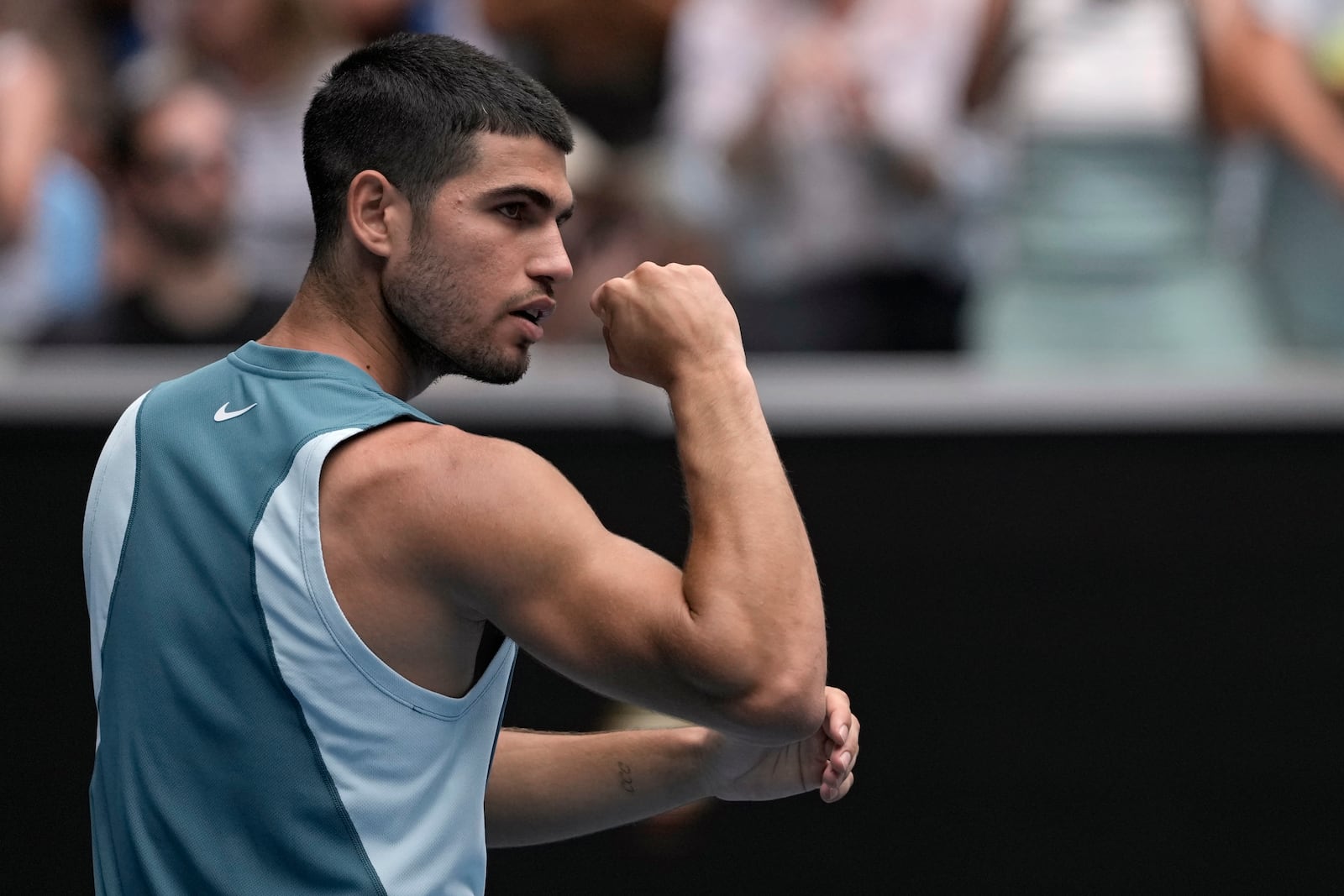 Carlos Alcaraz of Spain reacts after defeating Yoshihito Nishioka of Japan in their second round match at the Australian Open tennis championship in Melbourne, Australia, Wednesday, Jan. 15, 2025. (AP Photo/Ng Han Guan)