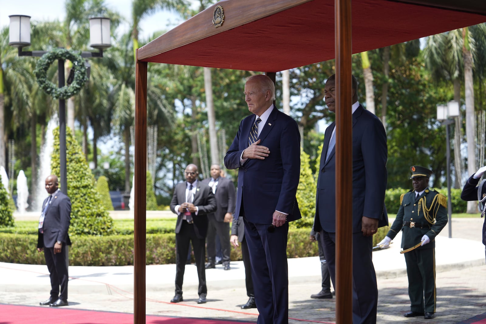 President Joe Biden stands for national anthems with Angola's President Joao Lourenco, at the presidential palace in the capital Luanda, Angola on Tuesday, Dec. 3, 2024. (AP Photo/Ben Curtis)