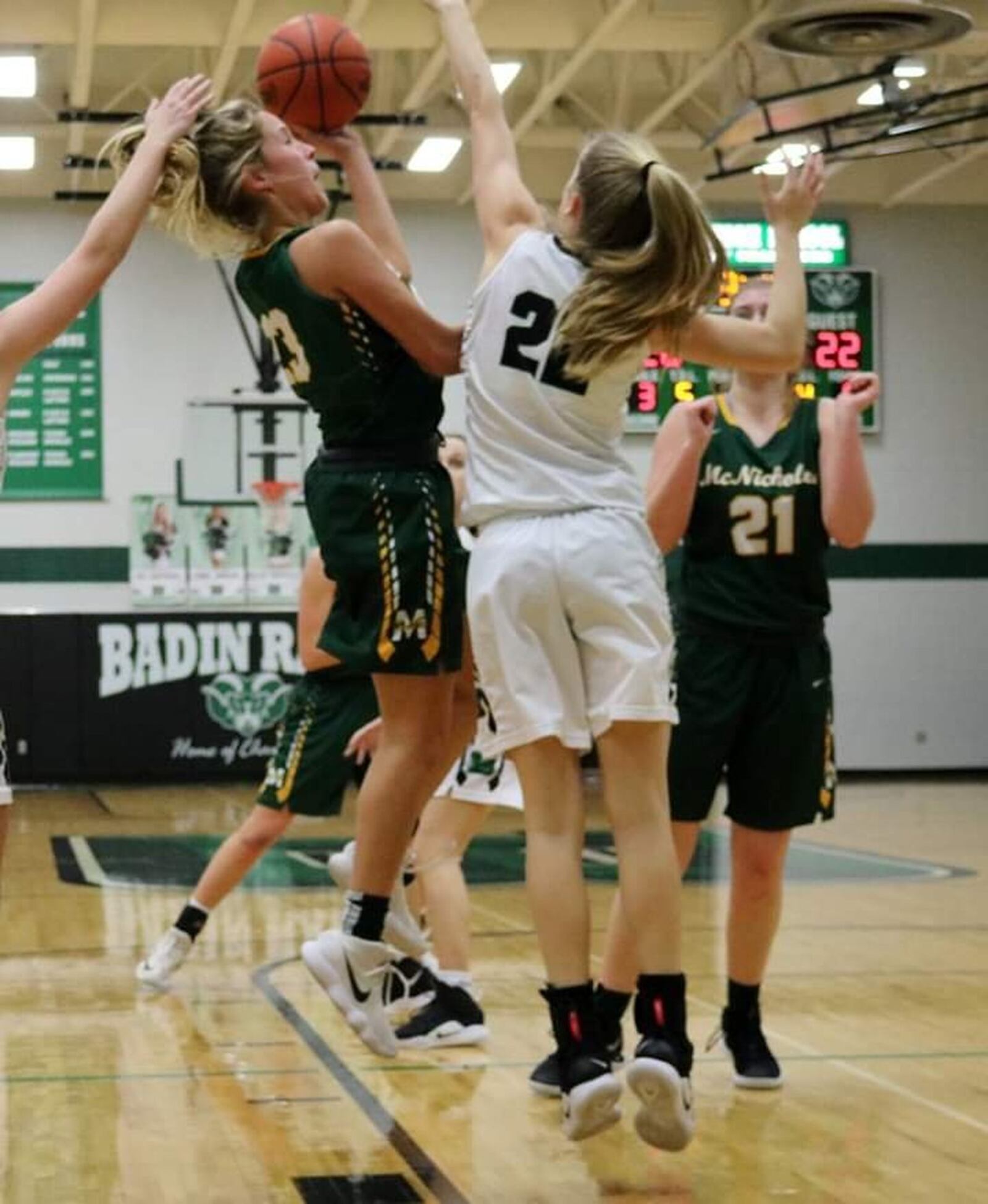 Badin’s Jada Pohlen (22) tries to block a shot by Christina Poole (23) of McNicholas during Wednesday night’s game at Mulcahey Gym in Hamilton. McNick won 53-51. CONTRIBUTED PHOTO BY TERRI ADAMS