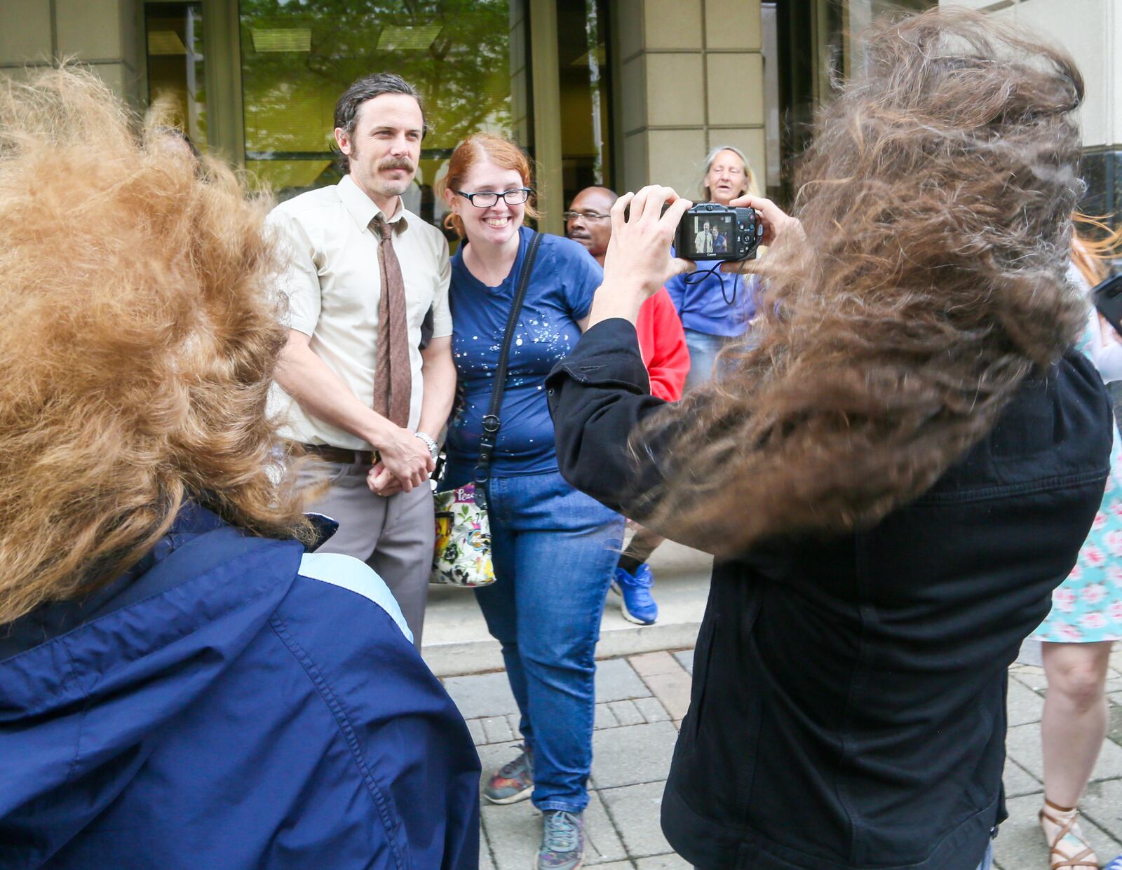 Casey Affleck poses for pictures with fans after finishing a scene for the Robert Redford movie The Old Man and the Gun, being filmed in Hamilton, Thursday, Apr. 27, 2017. GREG LYNCH / STAFF