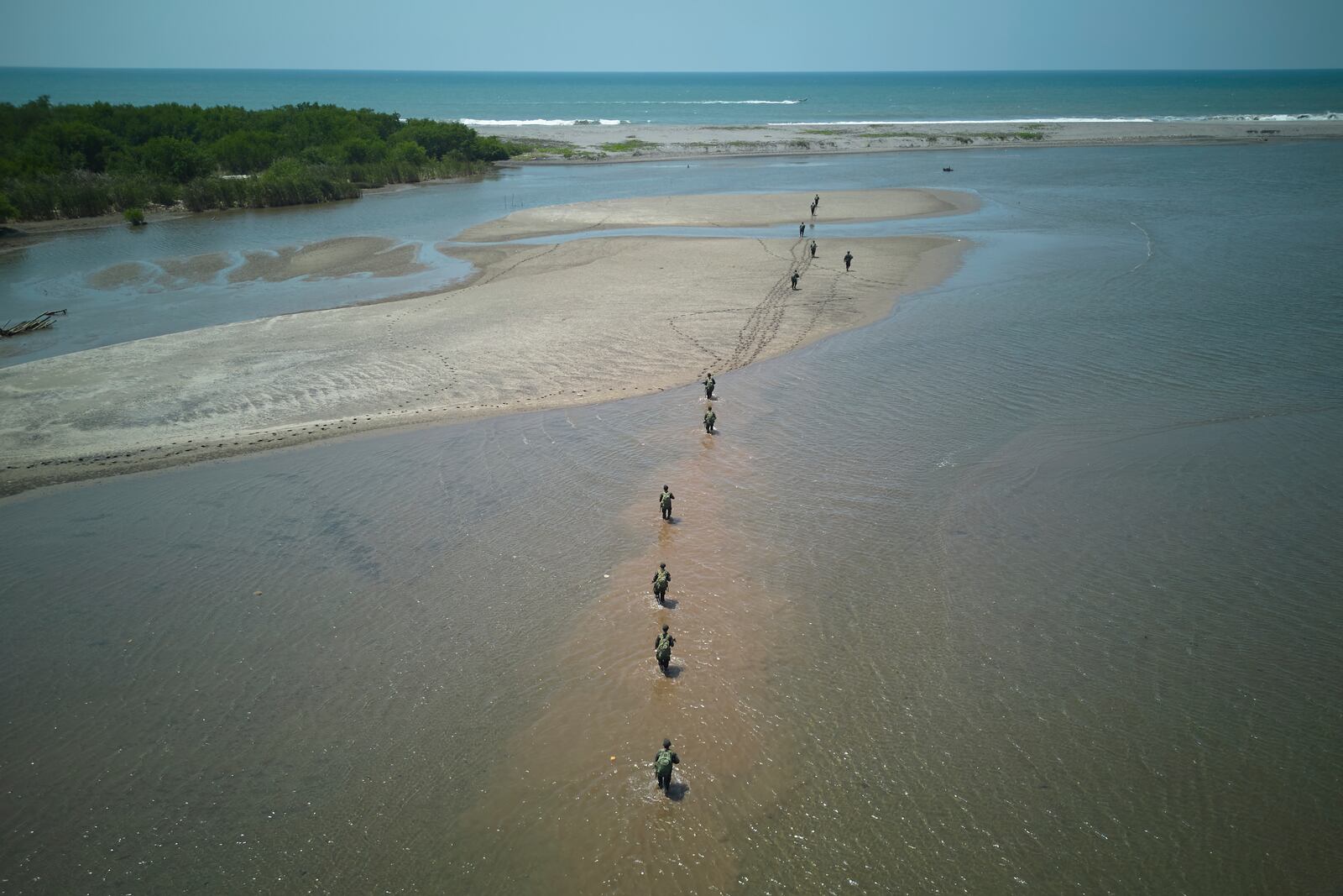 Guatemalan soldiers patrol the shared border with Mexico as part of the Ring of Fire operation, aiming to strengthen border control, at the mouth of Suchiate River in Ocos, Guatemala, Thursday, March 13, 2025. (AP Photo/Moises Castillo)