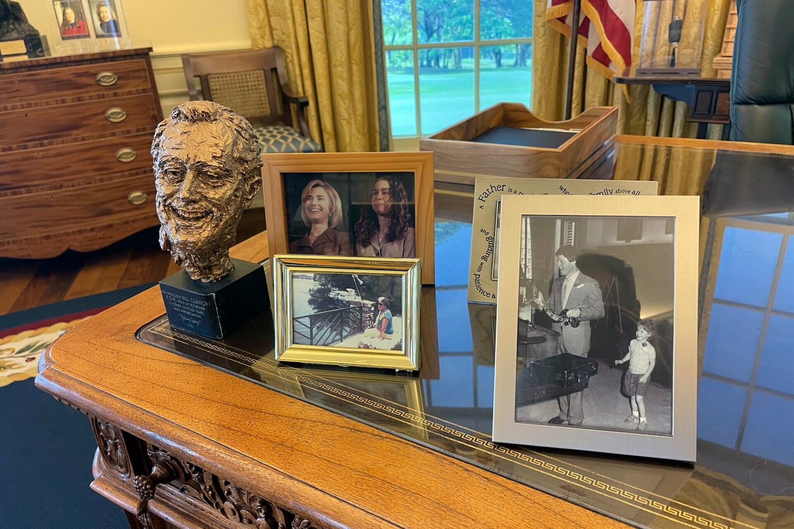 Photos and a bust of Franklin D. Roosevelt are displayed on a replica of the Resolute desk at the Clinton Presidential Library and Museum in Little Rock, Ark., Tuesday, Nov. 12, 2024. (AP Photo/Andrew DeMillo)