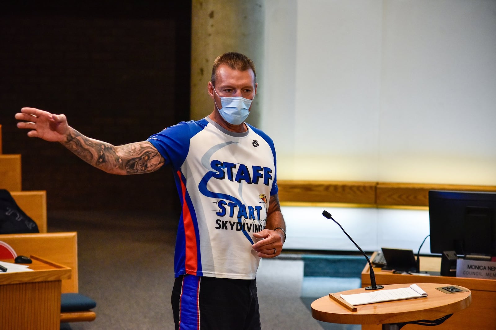 Larry Compton, chief tandem instructor for Start Skydiving and member of Team Fastrax, speaks in opposition to moving the skydiving drop zone locations during the council meeting Tuesday. Middletown City Council held their first in-person meeting since the coronavirus pandemic started Tuesday, May 19, 2020. Temperatures were taken as attendees filed in and seats were spaced out to meet social distancing guidelines. NICK GRAHAM / STAFF