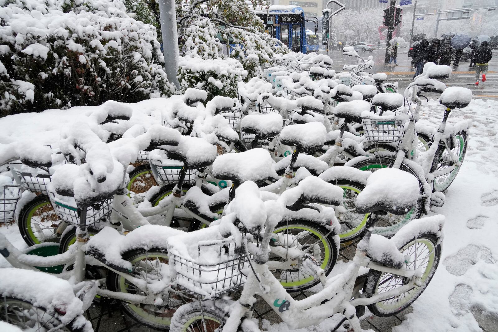 Snow-covered bicycles are parked near a subway station in Seoul, South Korea, Wednesday, Nov. 27, 2024. (AP Photo/Ahn Young-joon)