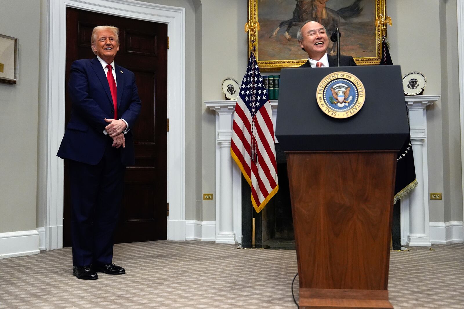 President Donald Trump laughs with Masayoshi Son, SoftBank Group CEO, in the Roosevelt Room at the White House, Tuesday, Jan. 21, 2025, in Washington. (AP Photo/Julia Demaree Nikhinson)