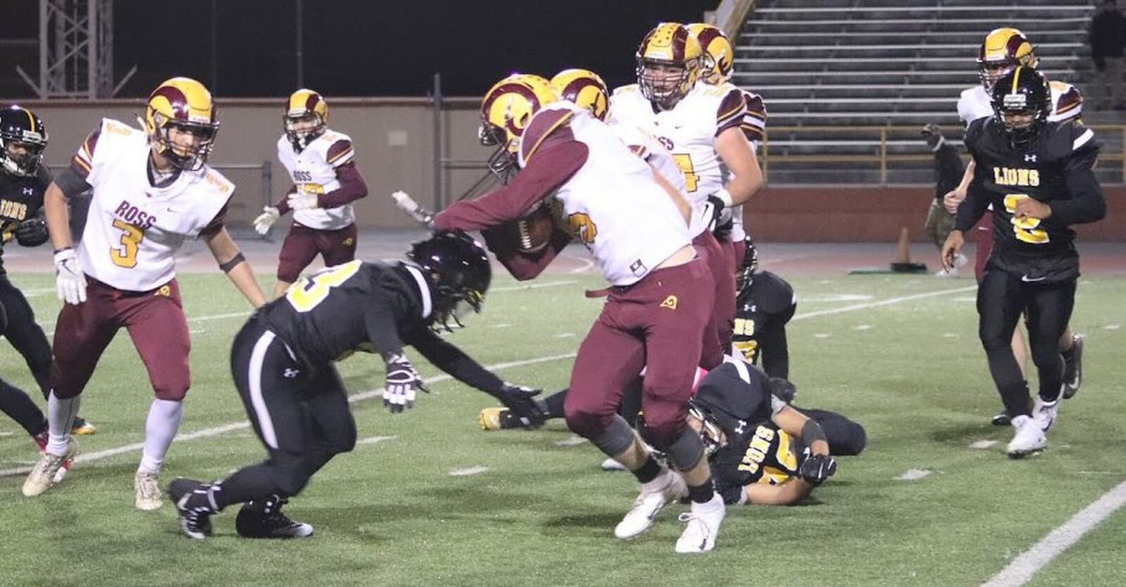 Dylan Caldwell (15) of Ross tries to elude a Meadowdale tackle on Thursday night at Welcome Stadium in Dayton. the Visiting Rams won 52-6. CONTRIBUTED PHOTO BY KAREN REDEMEIER