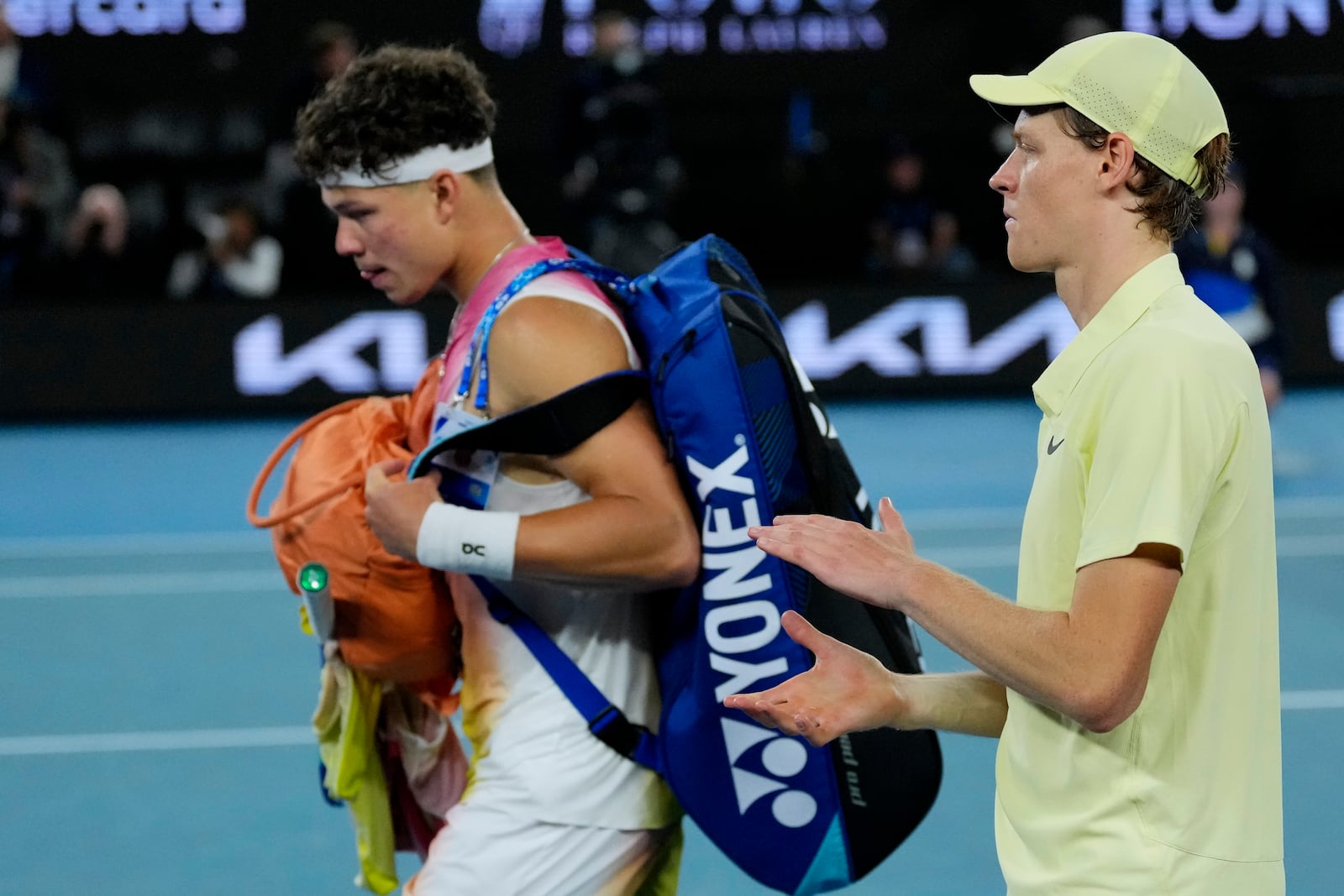 Jannik Sinner of Italy reacts as Ben Shelton of the U.S. leaves Rod Laver Arena following their semifinal match at the Australian Open tennis championship in Melbourne, Australia, Friday, Jan. 24, 2025. (AP Photo/Vincent Thian)