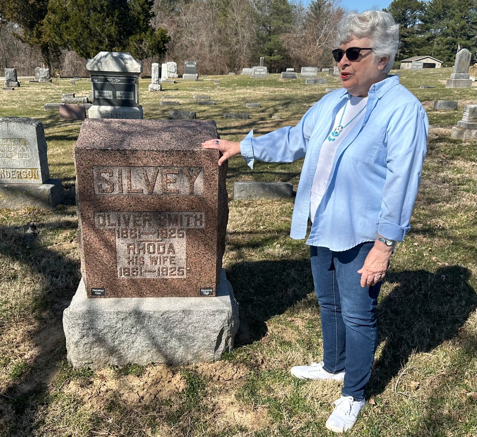 Sylvia Carvell, 81, of Murphybsoro, appears in this March 11, 2025 photo near the grave in Tower Grove Cemetery of her great-grandparents, (AP Photo/John O'Connor)