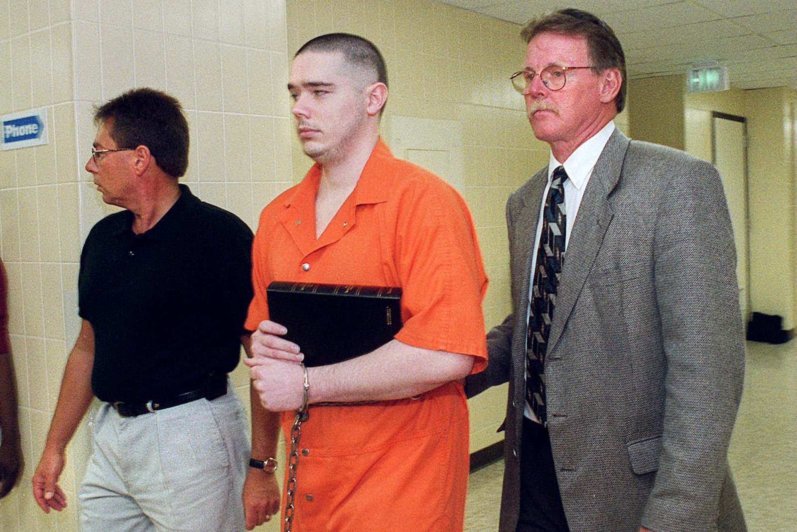 Joseph Corcoran is led to the City-County Lockup on Aug. 26, 1999, in Fort Wayne, Ind., after being sentenced to death in the slayings of four people in July 1997. (Matt Sullivan/The Journal-Gazette via AP)