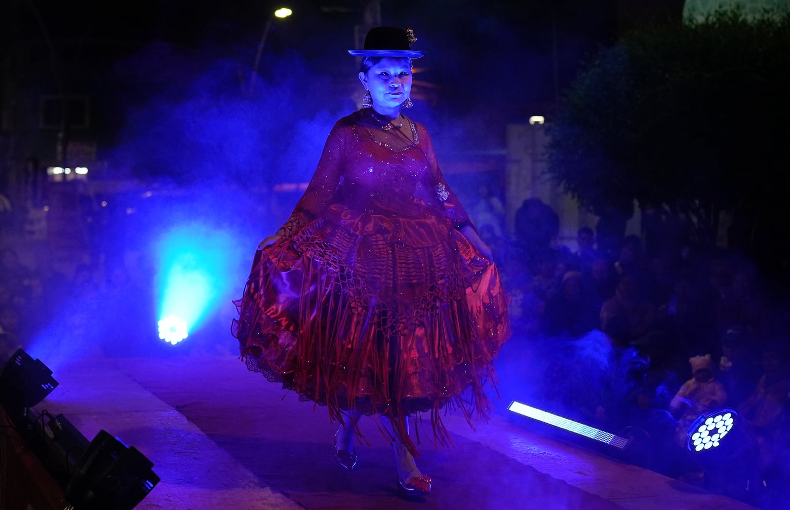 A woman models a creation by a local designer at a Chola fashion show, promoting the Andean style and beauty of Aymara women, in Viacha, Bolivia, Friday, Nov. 29, 2024. (AP Photo/Juan Karita)