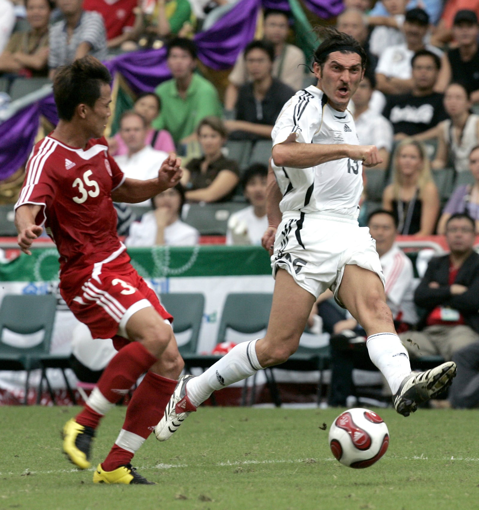 FILE - FIFA World Stars team's Mikheil Kavelashvili, right, makes a shot on the goal during the Reunification Cup against Chinese national team in Hong Kong, on July 1, 2007. (AP Photo/Brian Ching, File)