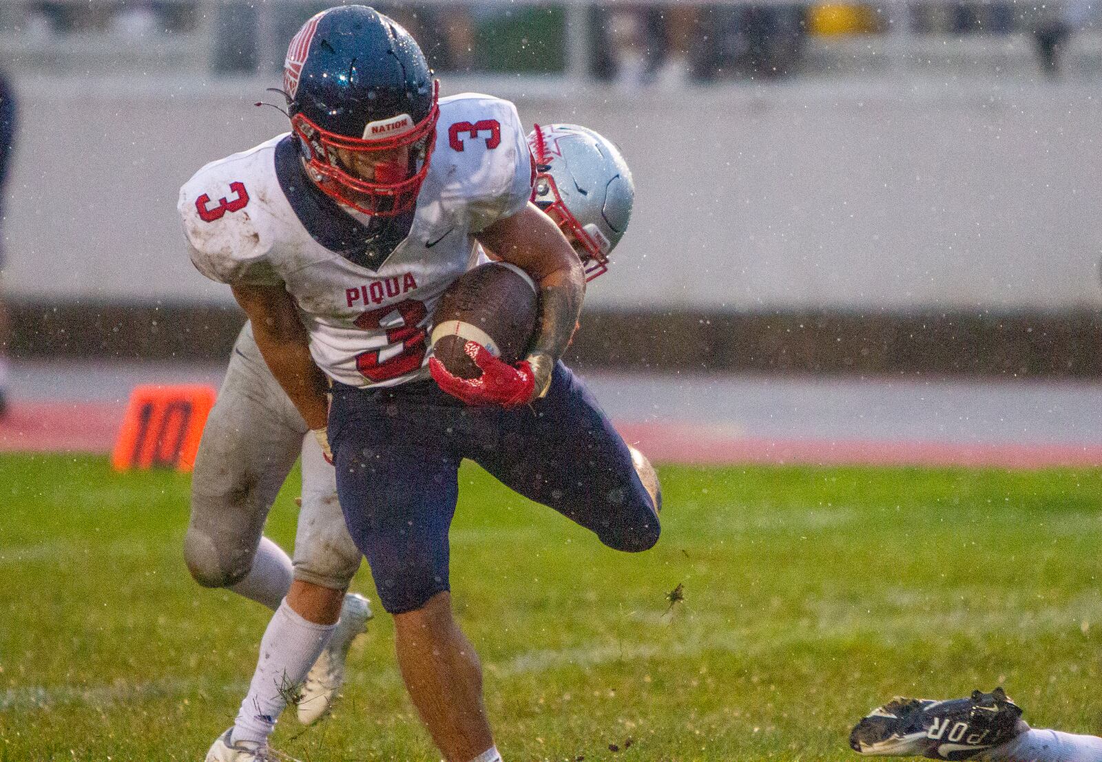 Piqua senior running back Jasiah Medley scores a touchdown in the rain against Troy in the first half Friday night at Troy. Jeff Gilbert/CONTRIBUTED