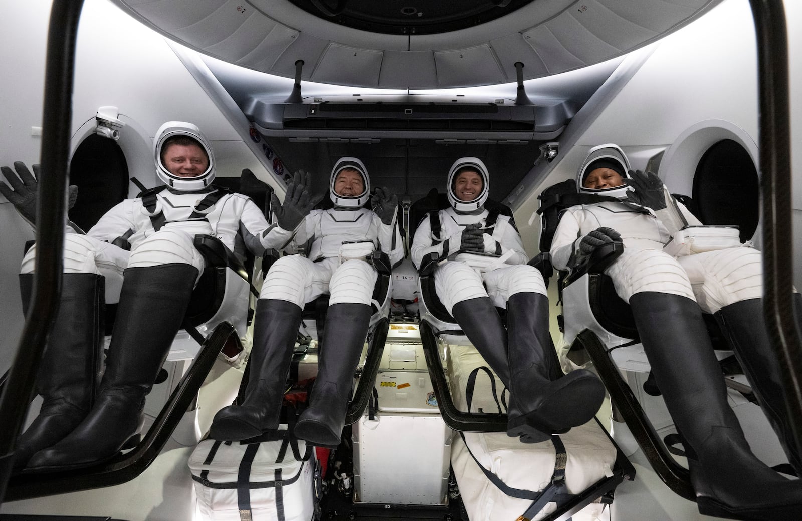 This photo provided by NASA shows Roscosmos cosmonaut Alexander Grebenkin, left, NASA astronauts Michael Barratt, second from left, Matthew Dominick, second from right, and Jeanette Epps, right, inside the SpaceX Dragon Endeavour spacecraft onboard the SpaceX recovery ship MEGAN shortly after having landed in the Gulf of Mexico off the coast of Pensacola, Florida, Friday, Oct. 25, 2024. (NASA/Joel Kowsky via AP)