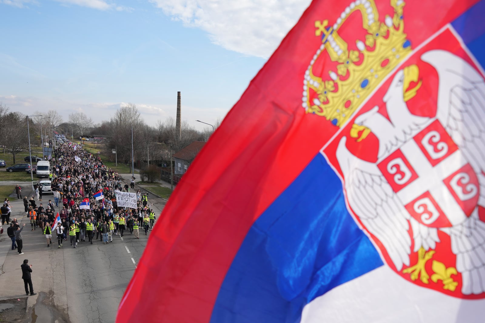 Students walk on the road towards the northern city of Novi Sad, where they will participate in a 24 hour block of three bridges to protest the deaths of 15 people killed in the November collapse of a train station canopy, near the Belgrade suburb of Batajnica, Serbia, Thursday, Jan. 30, 2025. (AP Photo/Darko Vojinovic)