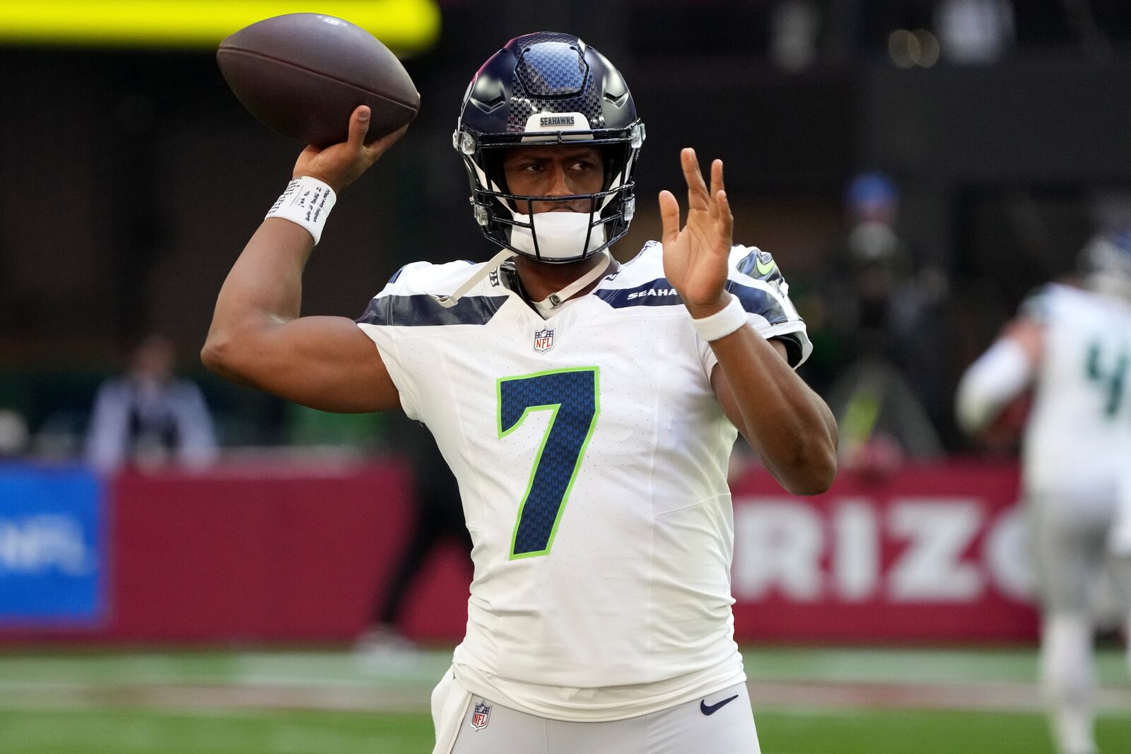 Seattle Seahawks quarterback Geno Smith (7) warms up prior to an NFL football game against the Arizona Cardinals, Sunday, Dec. 8, 2024, in Glendale, Ariz. (AP Photo/Rick Scuteri)