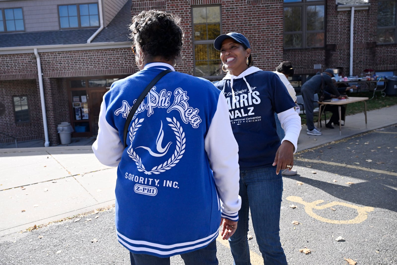 Linda Chapman of Waterbury, left, a member of the Zeta Phi Beta, talks with U.S. Rep. Jahana Hayes, D-Conn. at a Souls to the Polls voting rally at Grace Baptist Church, Oct. 26, 2024, in Waterbury, Conn. (AP Photo/Jessica Hill)