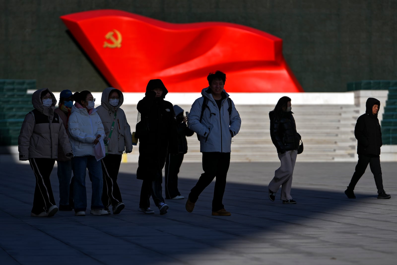 People walk past a sculpture of the Chinese Communist Party flag at the Museum of the Communist Party of China, in Beijing on Jan. 14, 2025. (AP Photo/Andy Wong)