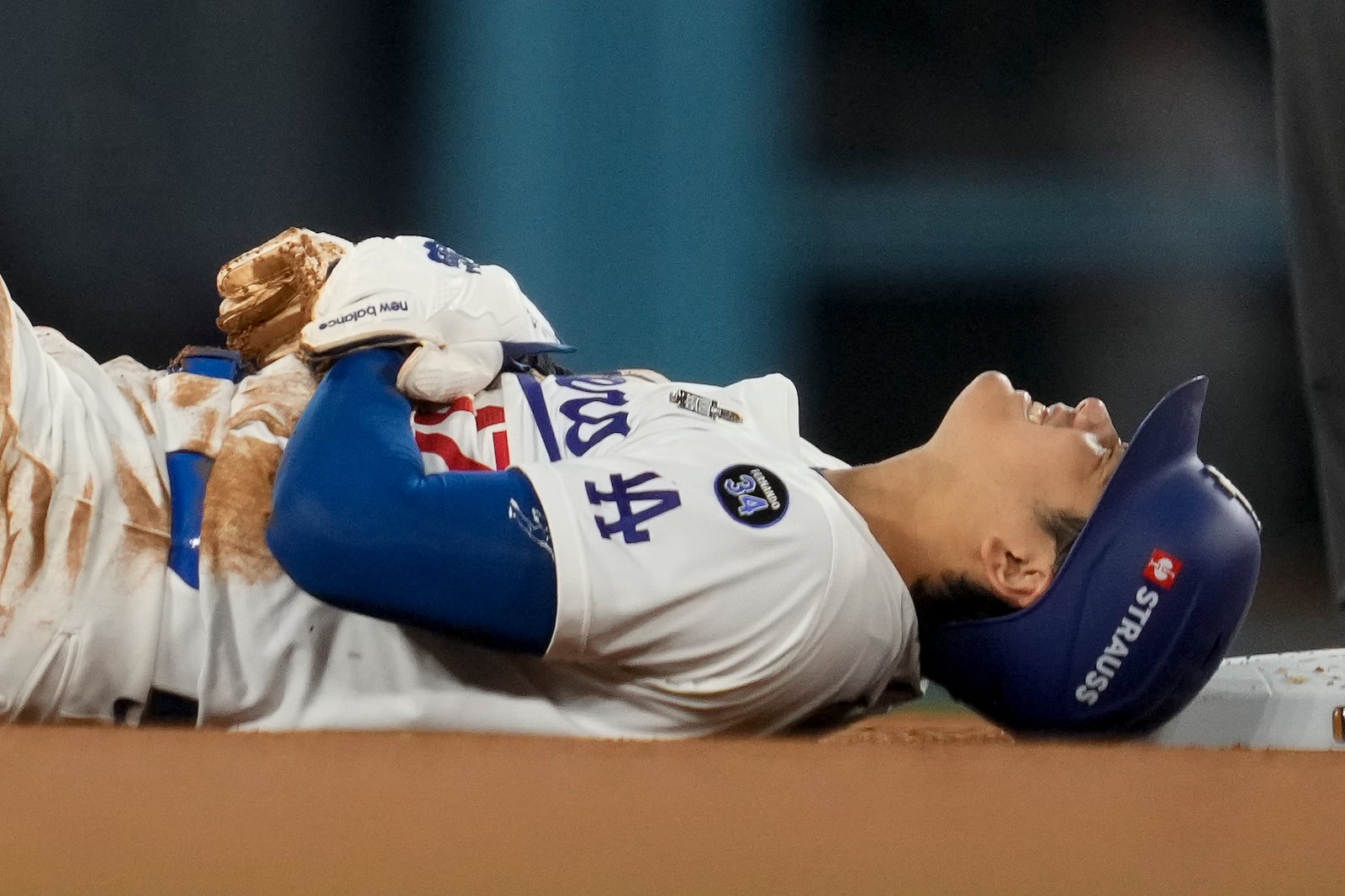 Los Angeles Dodgers' Shohei Ohtani is gets hurt sliding into second base during the seventh inning in Game 2 of the baseball World Series against the New York Yankees, Saturday, Oct. 26, 2024, in Los Angeles. (AP Photo/Ashley Landis)