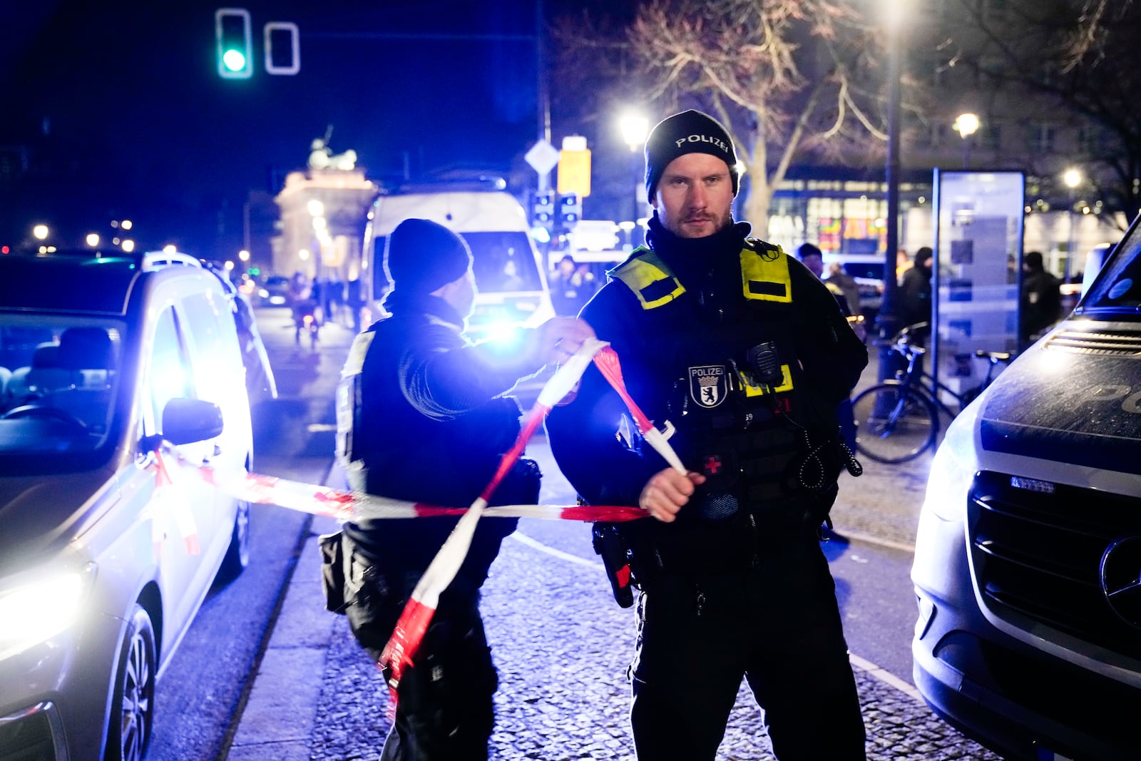 Police officers attend the scene at the Holocaust memorial after a man was attacked at the memorial site in Berlin, Germany, Friday, Feb. 21, 2025. (AP Photo/Ebrahim Noroozi)