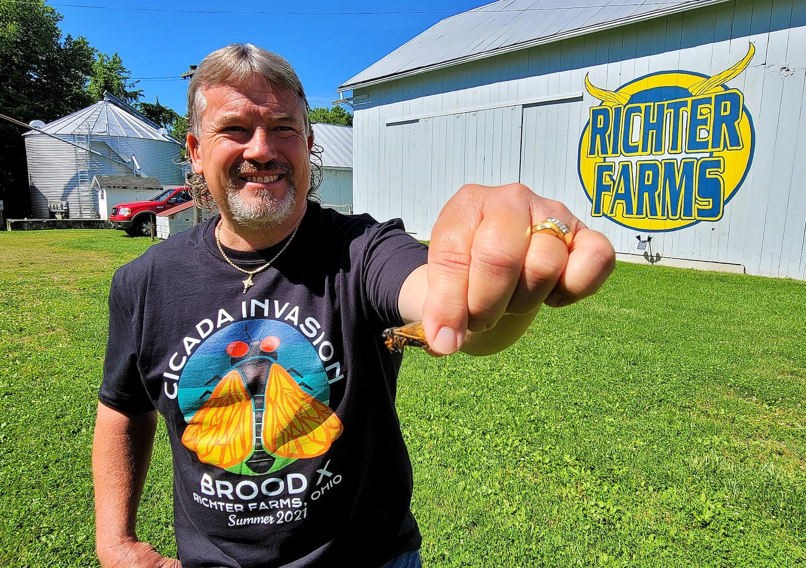 Dale Richter found a rare Brood X blue-eyed cicada after two days of searching his 151-acre soybean farm in Wayne Twp., where he said the cicadas seem to prefer his sugar maple trees on the property. NICK GRAHAM / STAFF