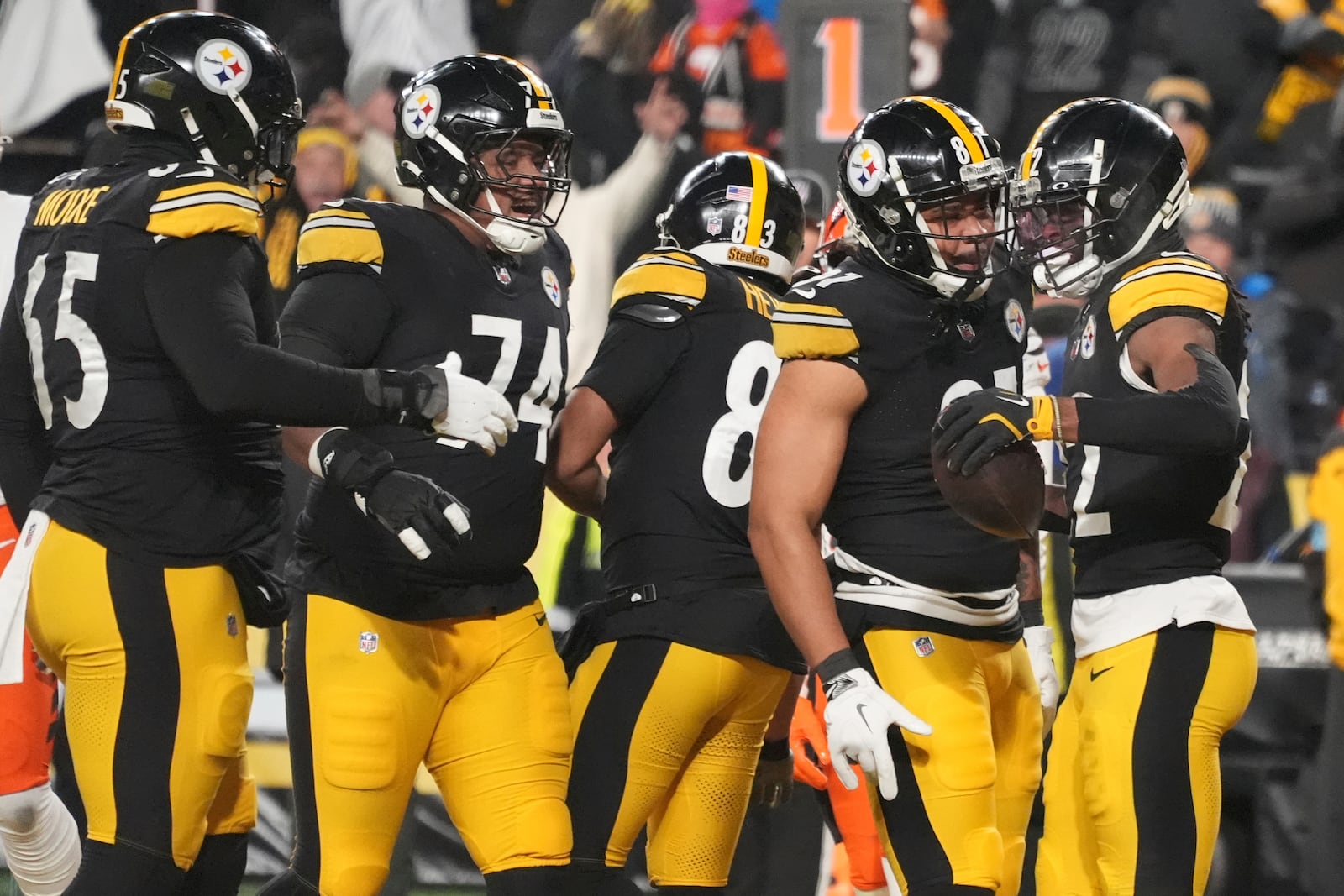 Pittsburgh Steelers running back Najee Harris (22), right, celebrates scoring a touchdown with offensive tackle Dan Moore Jr. (65), guard Spencer Anderson (74), tight end Connor Heyward (83), and tight end MyCole Pruitt (81), during the first half of an NFL football game against the Cincinnati Bengals in Pittsburgh Saturday, Jan. 4, 2025. (AP Photo/Gene J. Puskar)