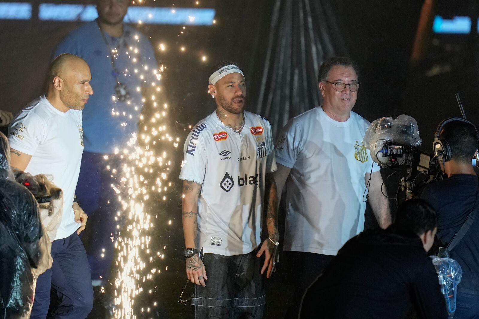 Brazilian soccer player Neymar, center, enters the pitch during his presentation ceremony after signing a six-month contract with Santos FC at Vila Belmiro Stadium in Santos, Brazil, Friday, Jan. 31, 2025. (AP Photo/Andre Penner)