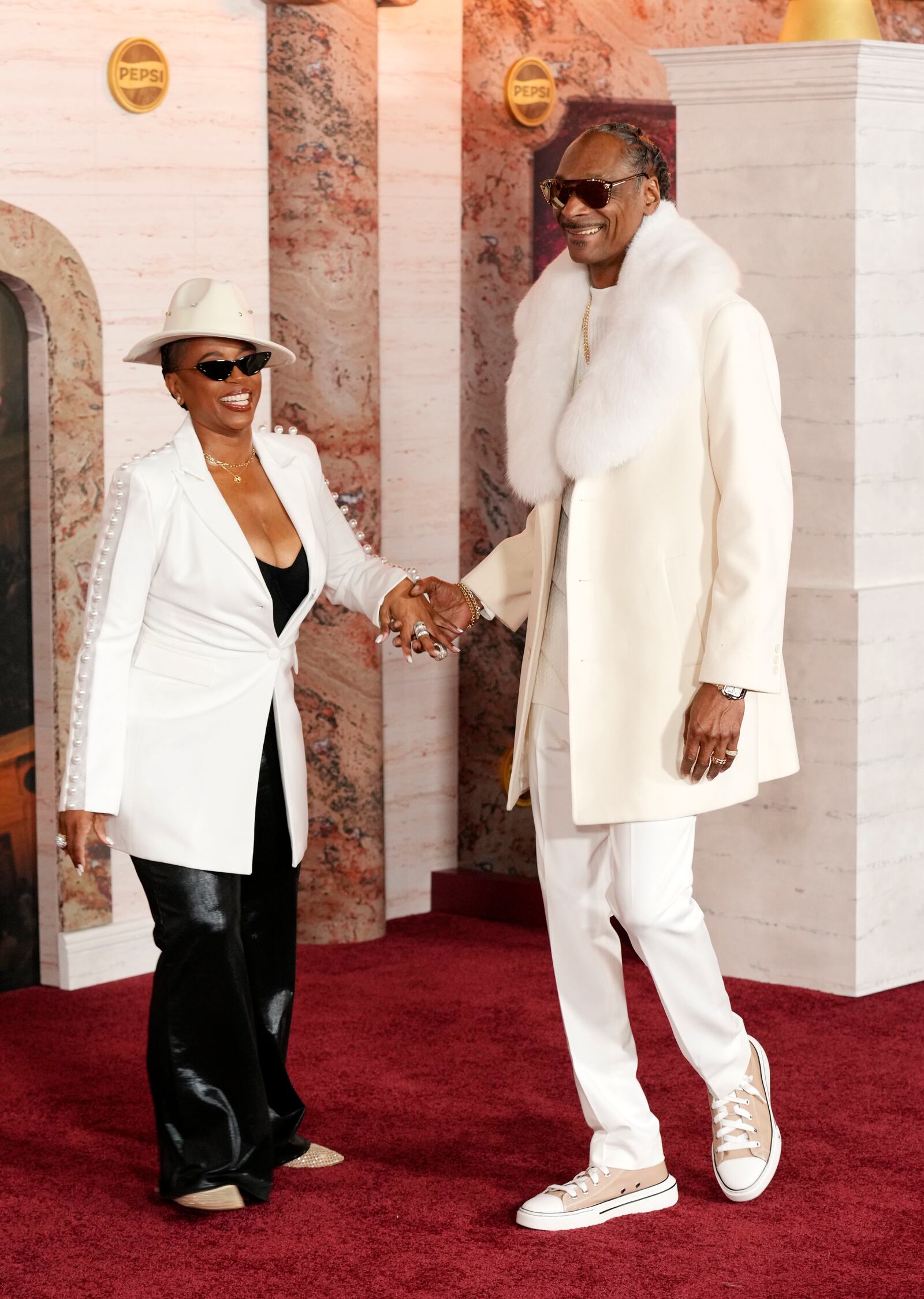 Snoop Dogg, right, and his wife Shante Broadus arrive at the premiere of the film "Gladiator II" on Monday, Nov. 18, 2024, at TCL Chinese Theatre in Los Angeles. (AP Photo/Chris Pizzello)