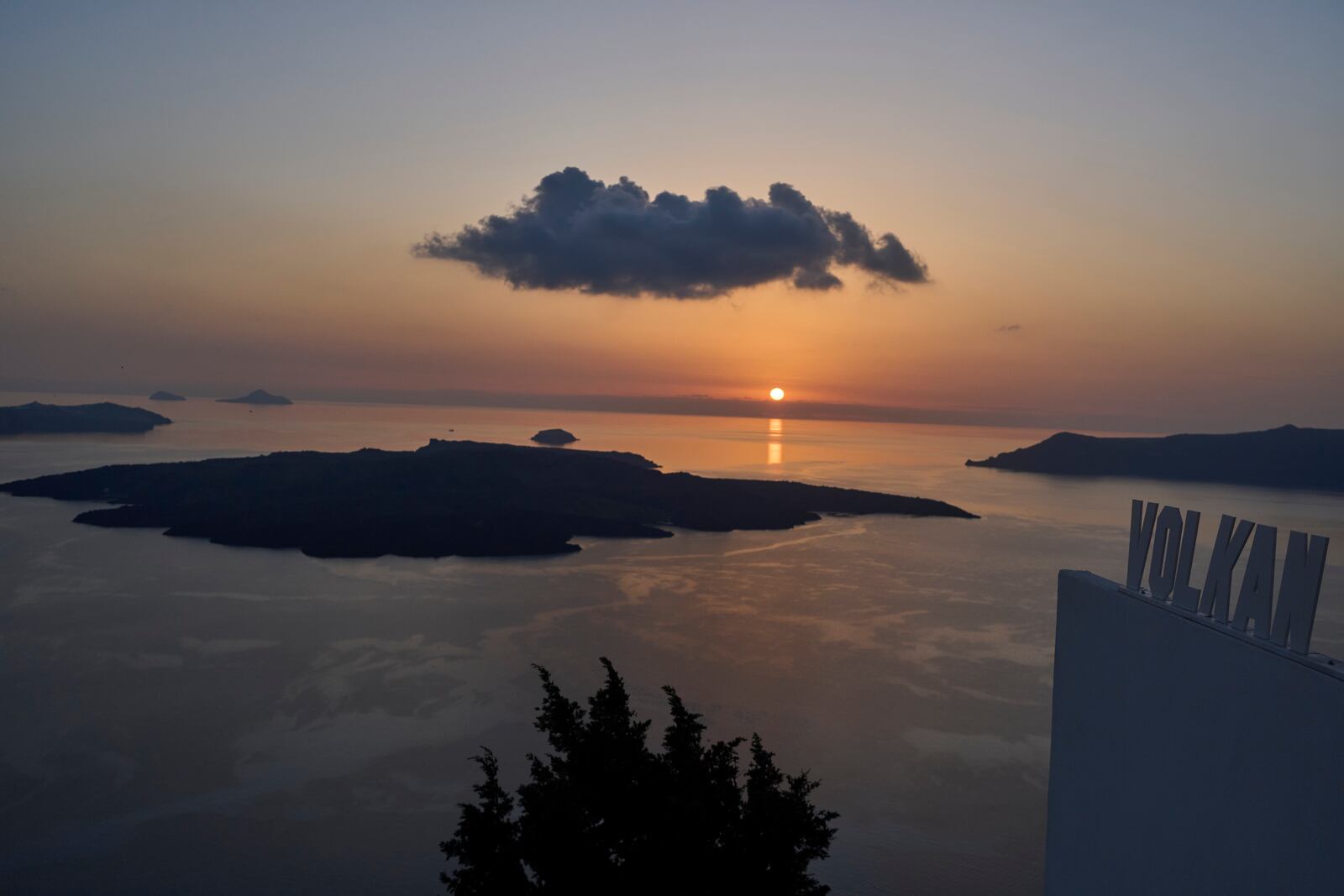 The sun sets behind the volcanic island of Nea Kameni, as authorities take emergency measures in response to intense seismic activity on the popular Aegean Sea holiday island of Santorini, southern Greece, Monday, Feb. 3, 2025. (AP Photo/Petros Giannakouris)