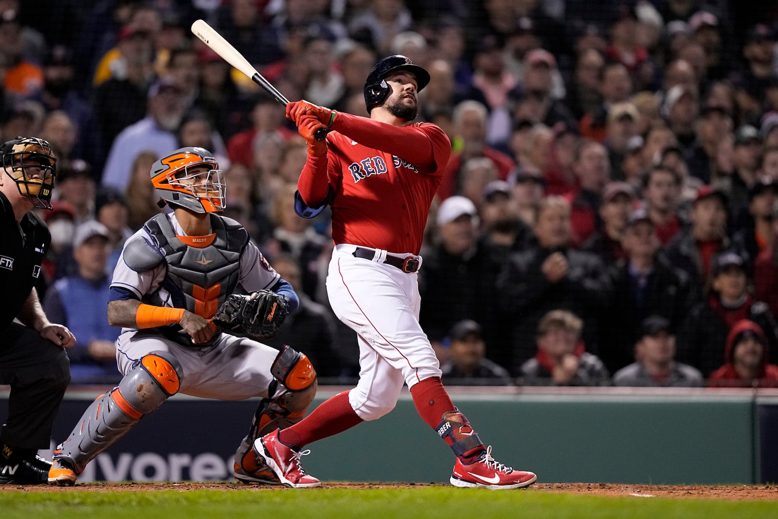 Boston Red Sox's Kyle Schwarber hits a grand slam home run against the Houston Astros during the second inning in Game 3 of baseball's American League Championship Series Monday, Oct. 18, 2021, in Boston. (AP Photo/David J. Phillip)