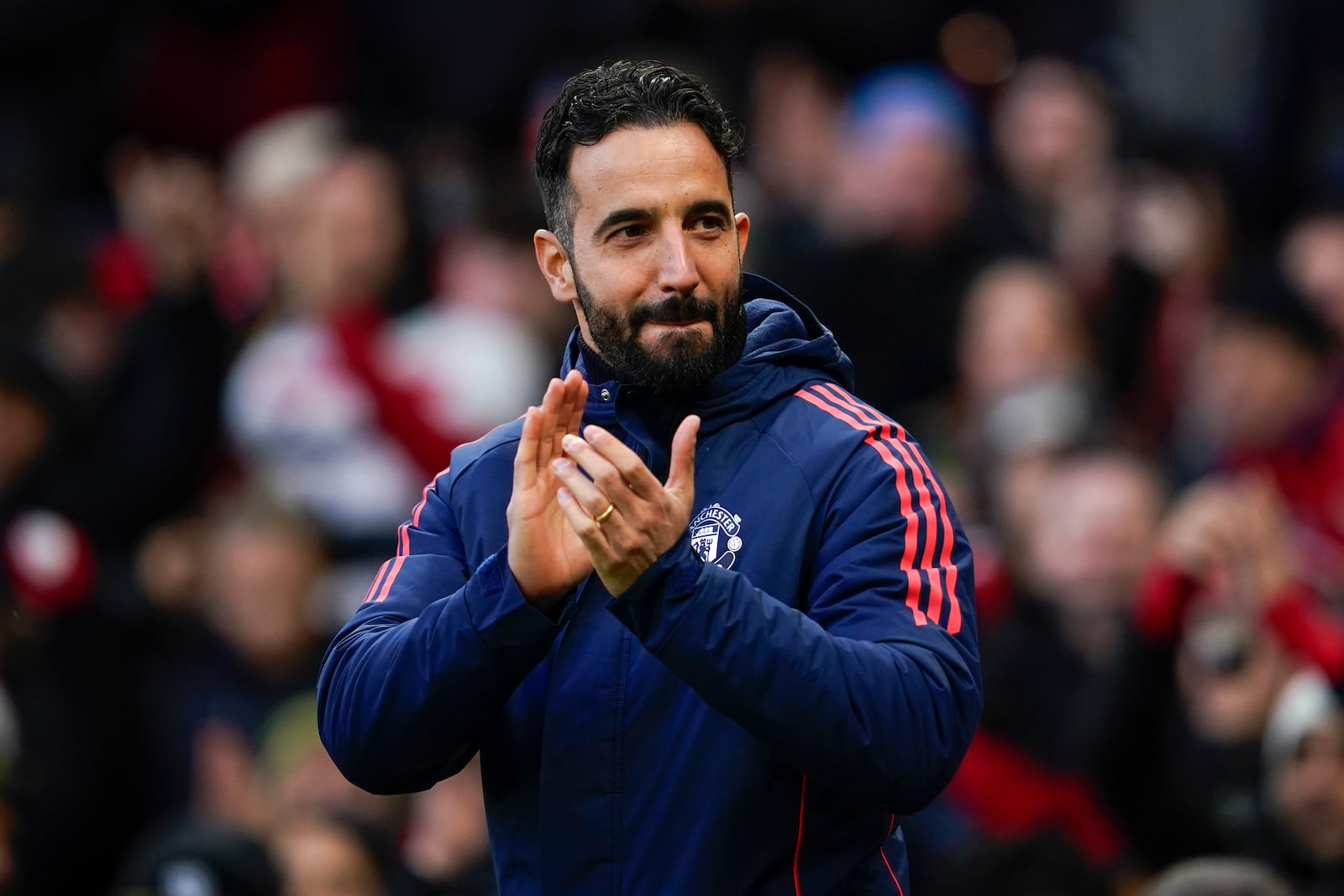 Manchester United's head coach Ruben Amorim claps his hands before the English Premier League soccer match between Manchester United and Bournemouth at the Old Trafford stadium in Manchester, England, Sunday, Dec. 22, 2024. (AP Photo/Dave Thompson)