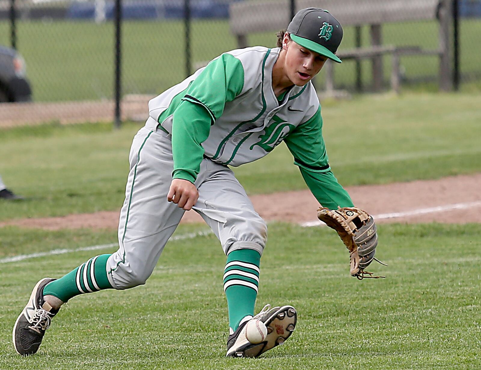 Badin third baseman Sam Mathews chases down a Chaminade Julienne bunt Thursday during a Division II sectional final at Miamisburg. CONTRIBUTED PHOTO BY E.L. HUBBARD