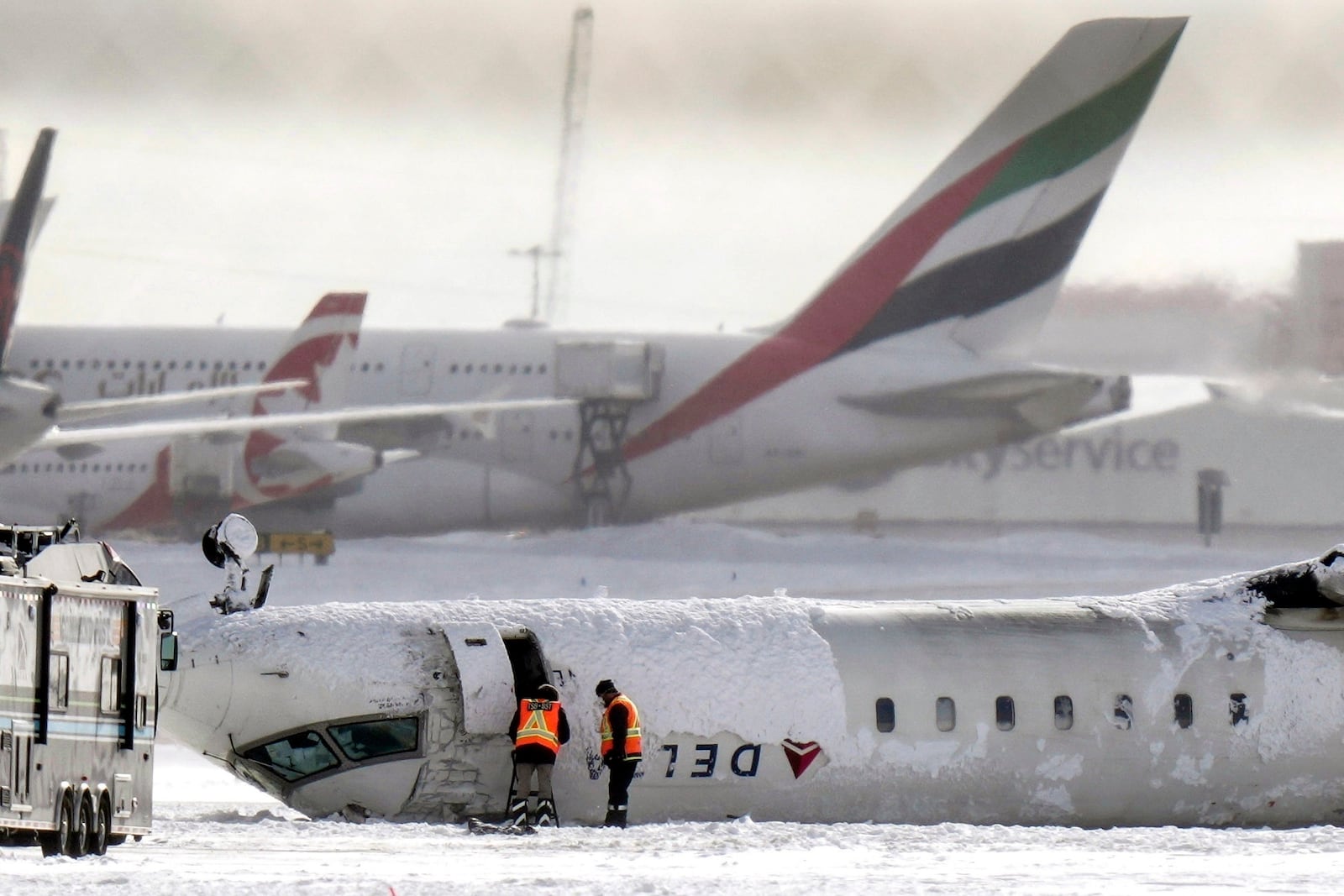 A Delta Air Lines plane lies upside down at Toronto Pearson Airport on Tuesday, Feb. 18, 2025. (Chris Young/The Canadian Press via AP)