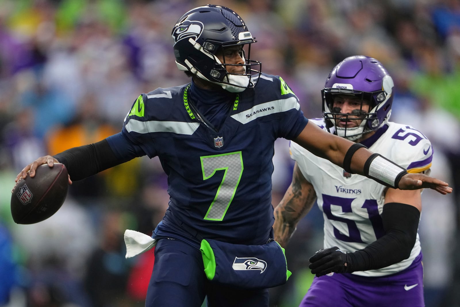 Seattle Seahawks quarterback Geno Smith (7) looks to pass while pressured by Minnesota Vikings linebacker Blake Cashman (51) during the second half of an NFL football game, Sunday, Dec. 22, 2024, in Seattle. (AP Photo/Lindsey Wasson)