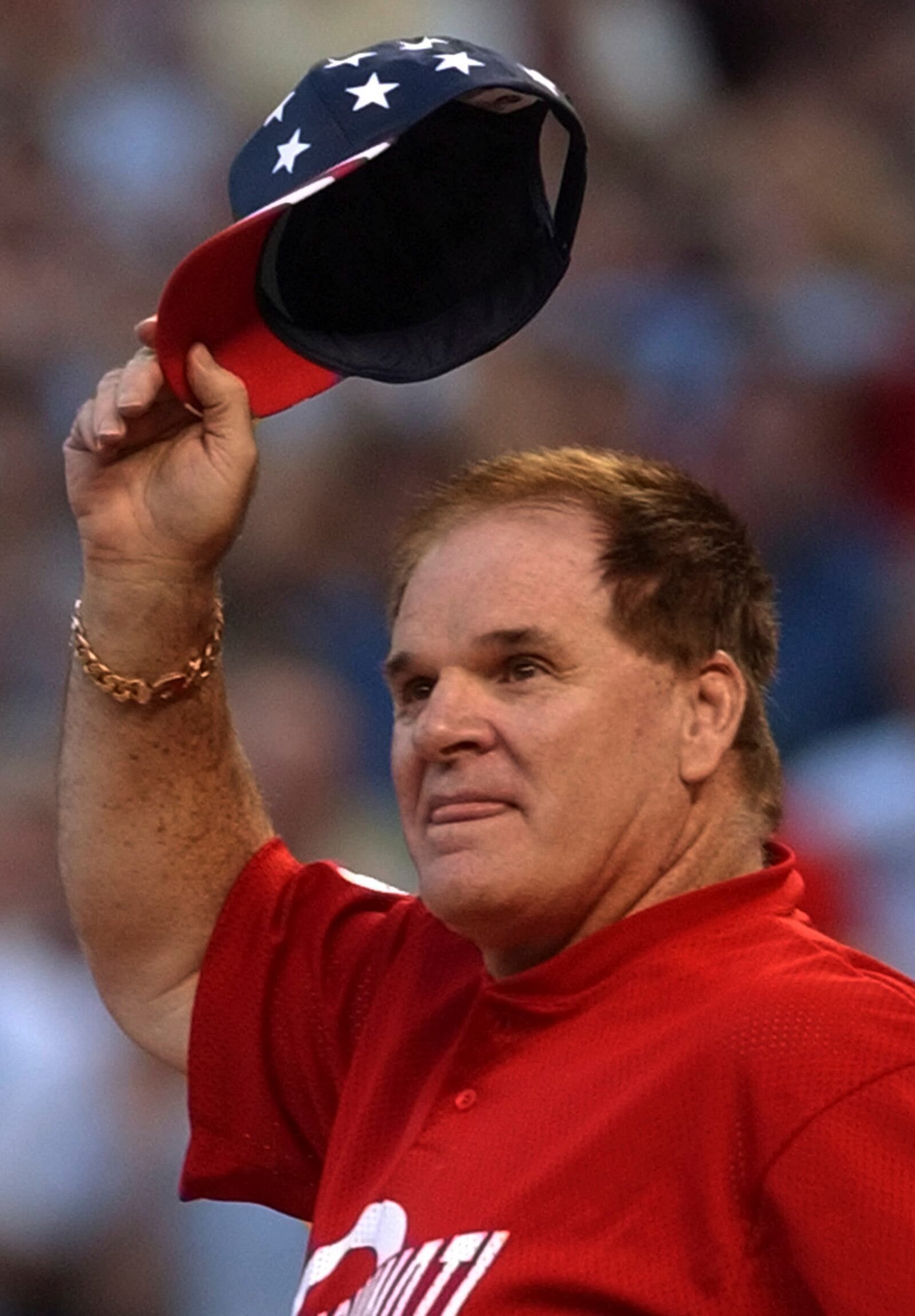 FILE - Pete Rose tips his hat as he is introduced at Cinergy Field, Monday, Sept. 23, 2002, in Cincinnati, where Rose and several retired major leaguers played a softball game. (AP Photo/Al Behrman, File)