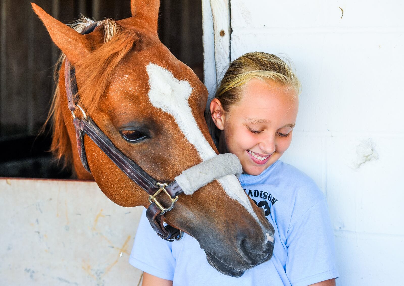 Lyla Comer, 10, with Madison Outlaws 4-H club stands with her horse, Annie, during the Butler County Fair Thursday, July 26 at the Butler County Fairgrounds in Hamilton. NICK GRAHAM/STAFF