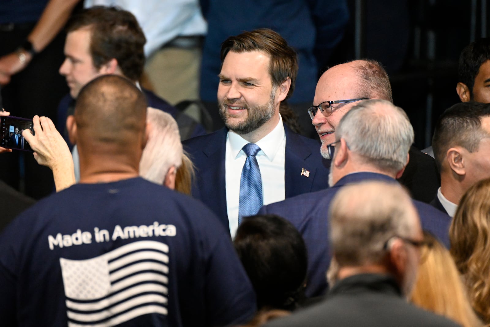 Vice President JD Vance, center, greets supporters following a rally where he spoke about "America's industrial resurgence," Friday, March 14, 2025, at Vantage Plastics in Bay City, Mich. (AP Photo/Jose Juarez)