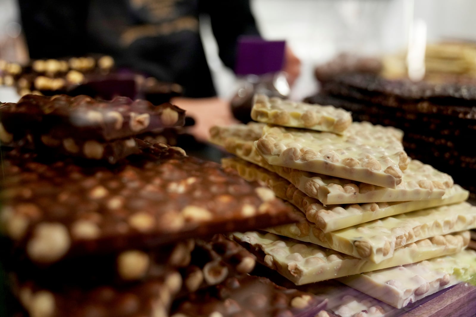 Chocolate bark is on display behind a glass counter at The Chocolate Line in Bruges, Belgium, Thursday, Feb. 6, 2025. (AP Photo/Virginia Mayo)