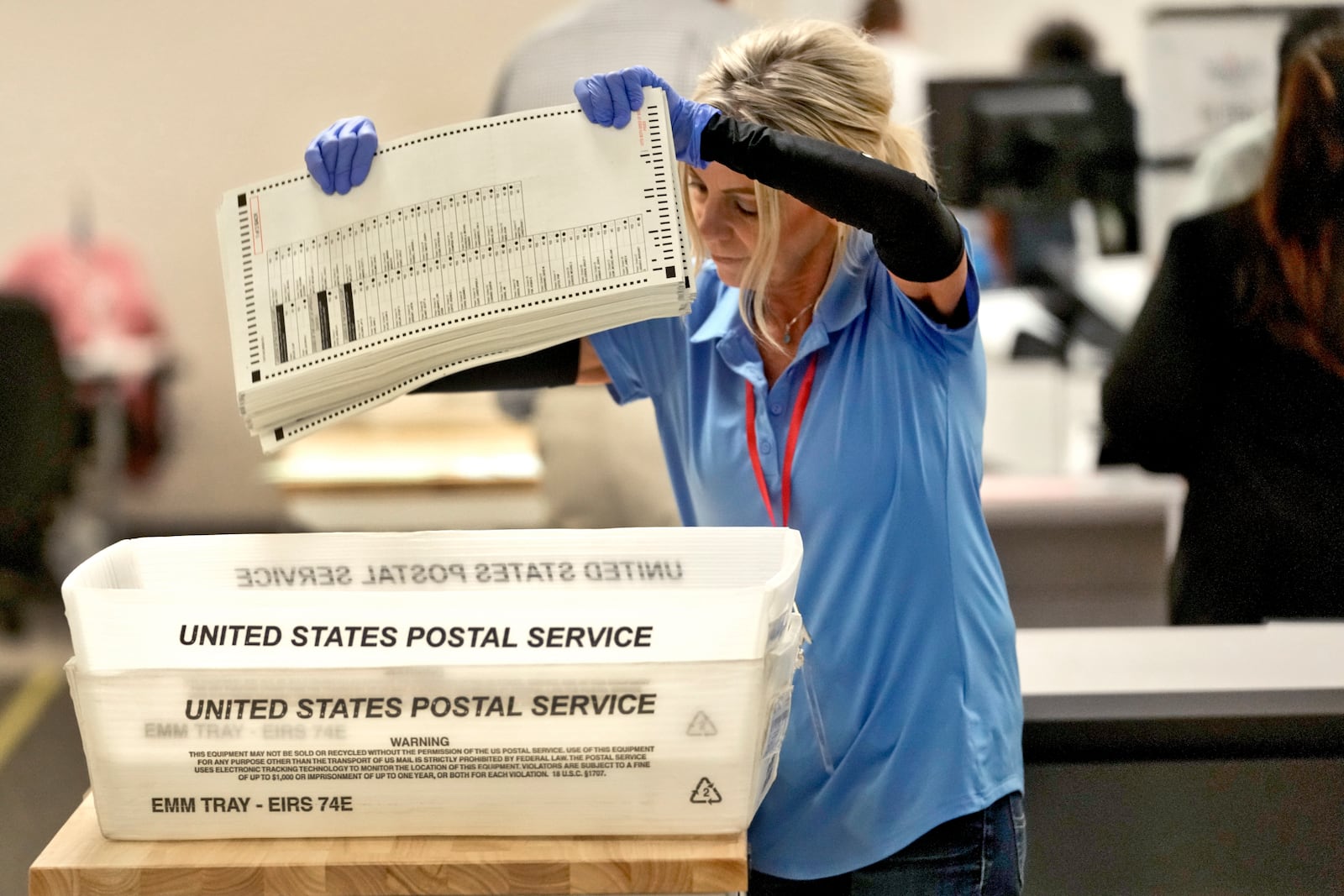 An elections official prepares to count mail-in ballots on the first day of tabulation, Wednesday, Oct. 23, 2024, at the Maricopa County Recorder's Office in Phoenix. (AP Photo/Matt York)