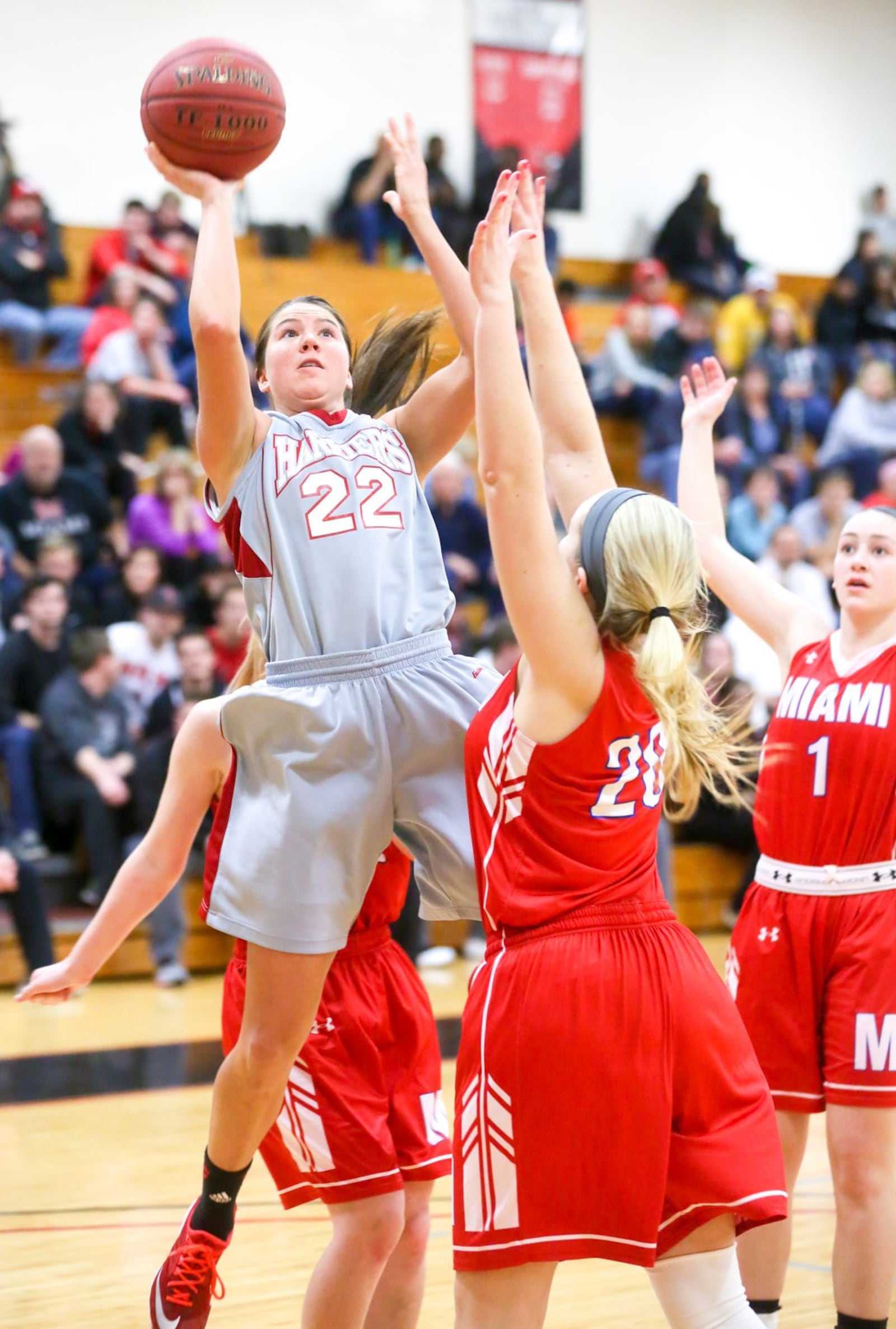 Miami Hamilton forward Jillian Spurlock (22) pulls up for a shot over Miami Middletown’s Jenna Bour on Wednesday night at MUH. GREG LYNCH/STAFF